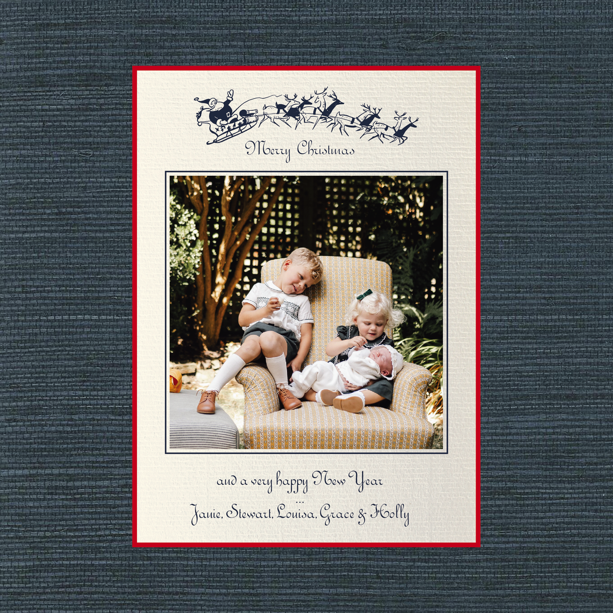 The Campbell personalized photo Christmas card by Stovall Collection, featuring vintage Santa and reindeer artwork, classic typography and a family photograph on creamy laid paper.