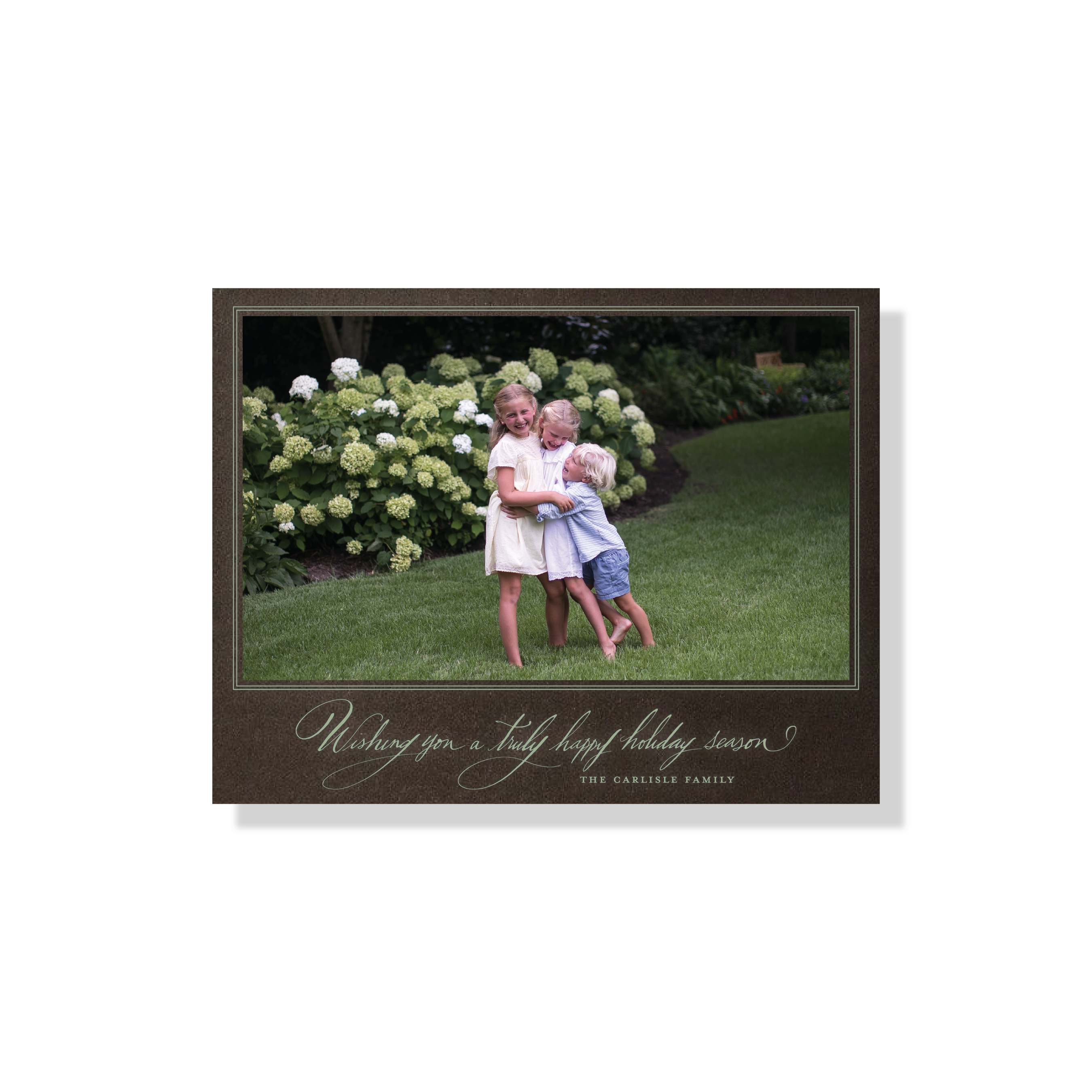 Carlisle Engraved Christmas Photo Card with elegant hand-lettered calligraphy, a personalized family photo, and crisp, raised engraved details.