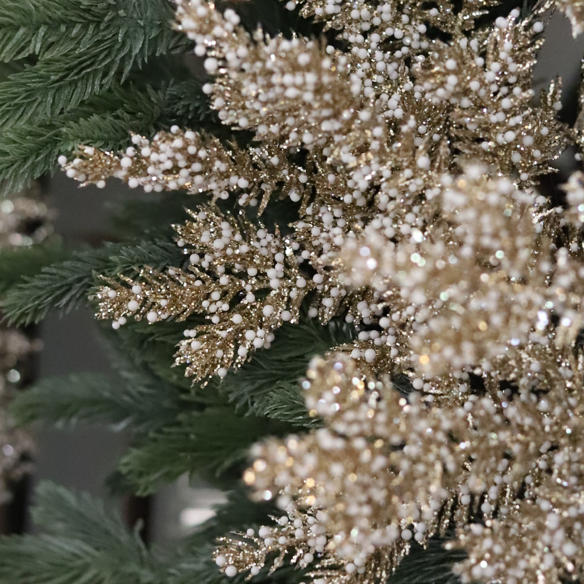 Close-up of Chatsworth Champagne Wreath with champagne glitter foliage and snowy white accents