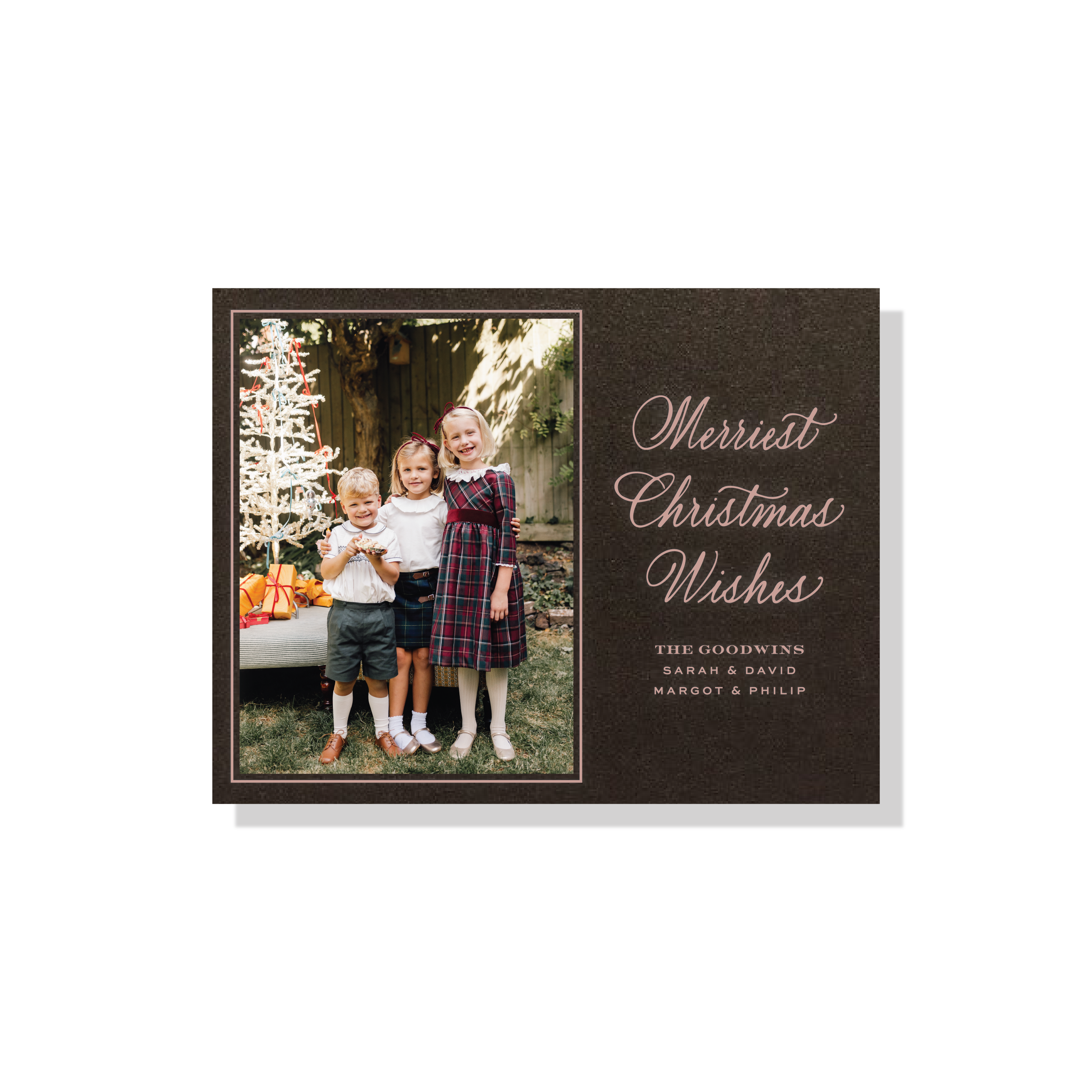 Goodwin Engraved Christmas Photo Card with a vertical family photo, graceful holiday calligraphy, and crisp raised engraved details.