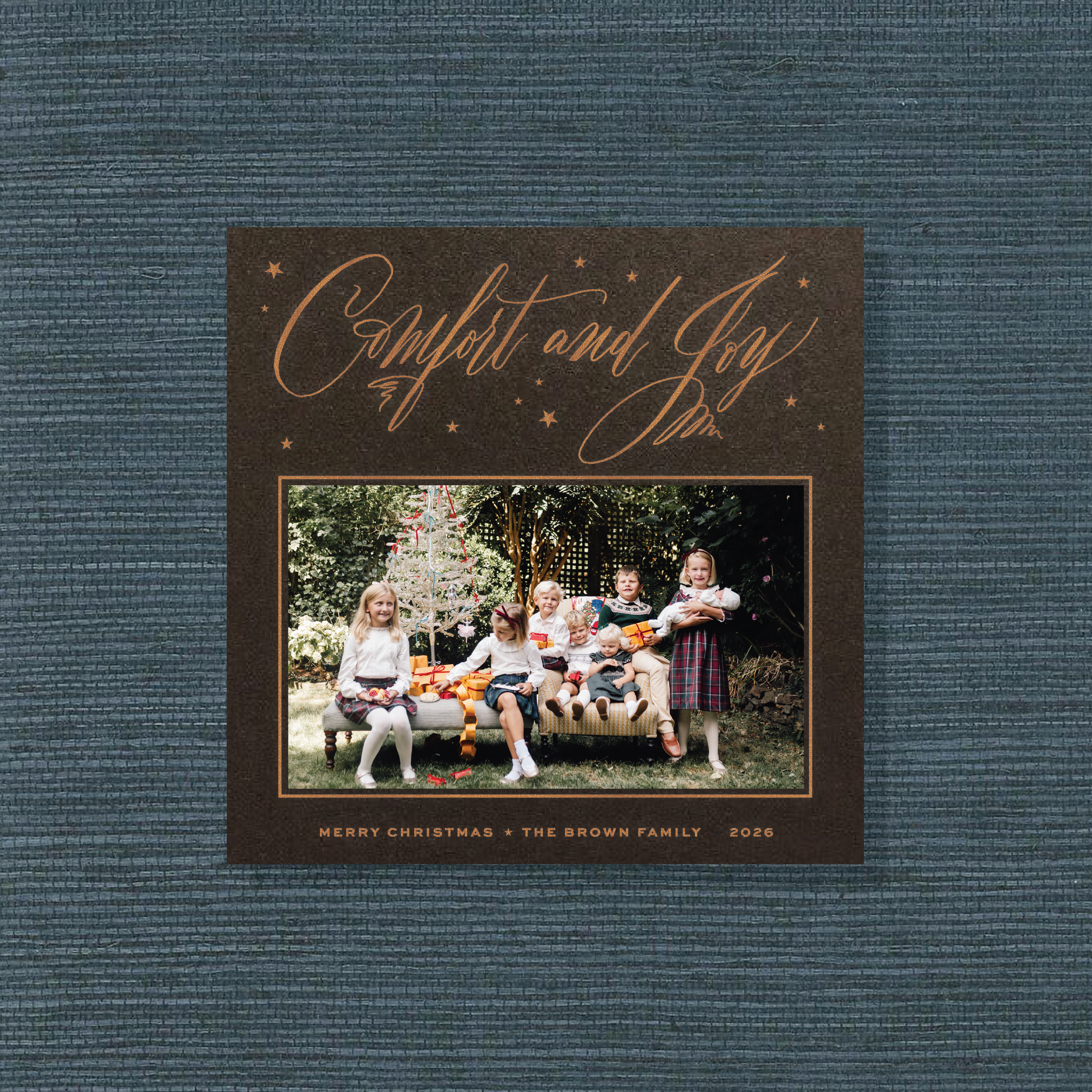 Hawthorne Engraved Christmas Photo Card with a family portrait, sweeping “Comfort and Joy” lettering, and crisp raised engraved details.
