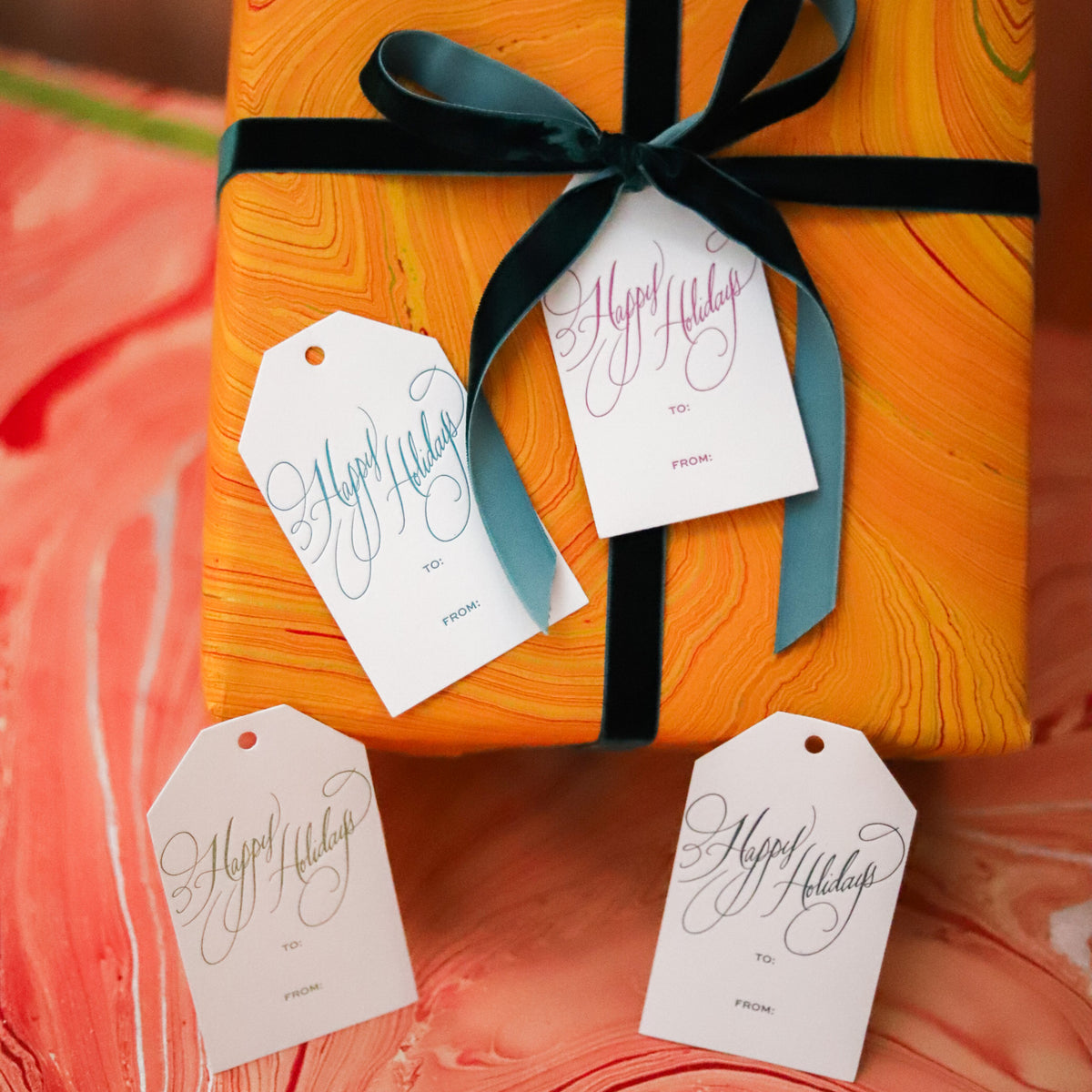 Shop Happy Holidays Gift Tags in sets of 8, featuring elegant hand-lettered lettering, To and From lines, and coordinating color options for festive gift wrapping.