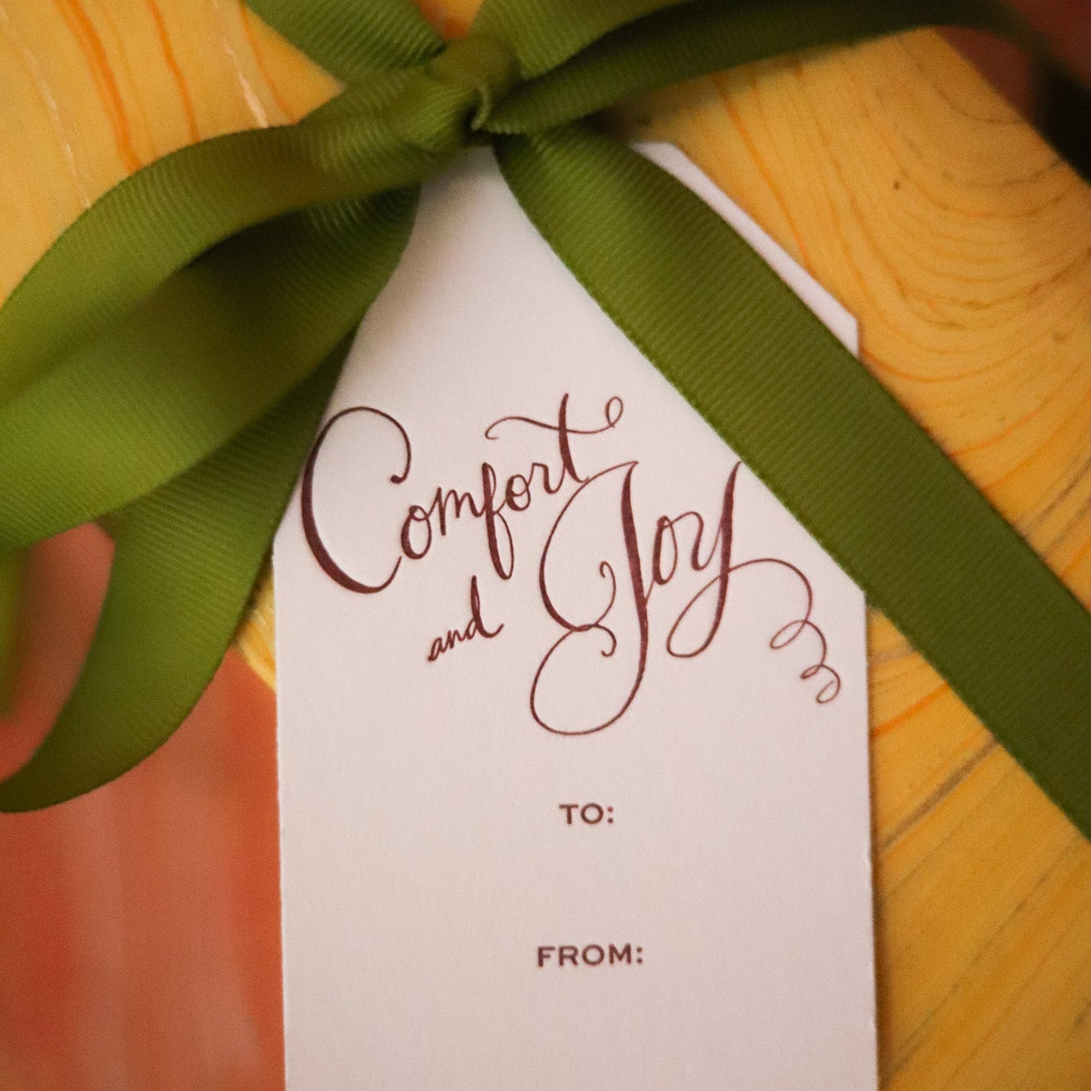 Shop Comfort & Joy Gift Tags in sets of 8, featuring hand-lettered lettering, To and From lines, and coordinating colors for festive Christmas wrapping.