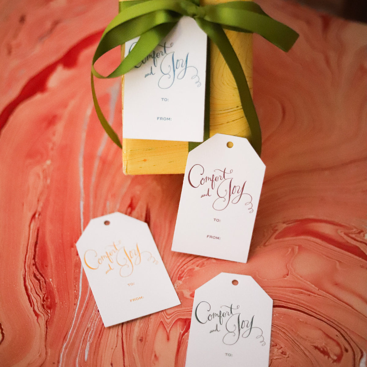 Shop Comfort & Joy Gift Tags in sets of 8, featuring hand-lettered lettering, To and From lines, and coordinating colors for festive Christmas wrapping.