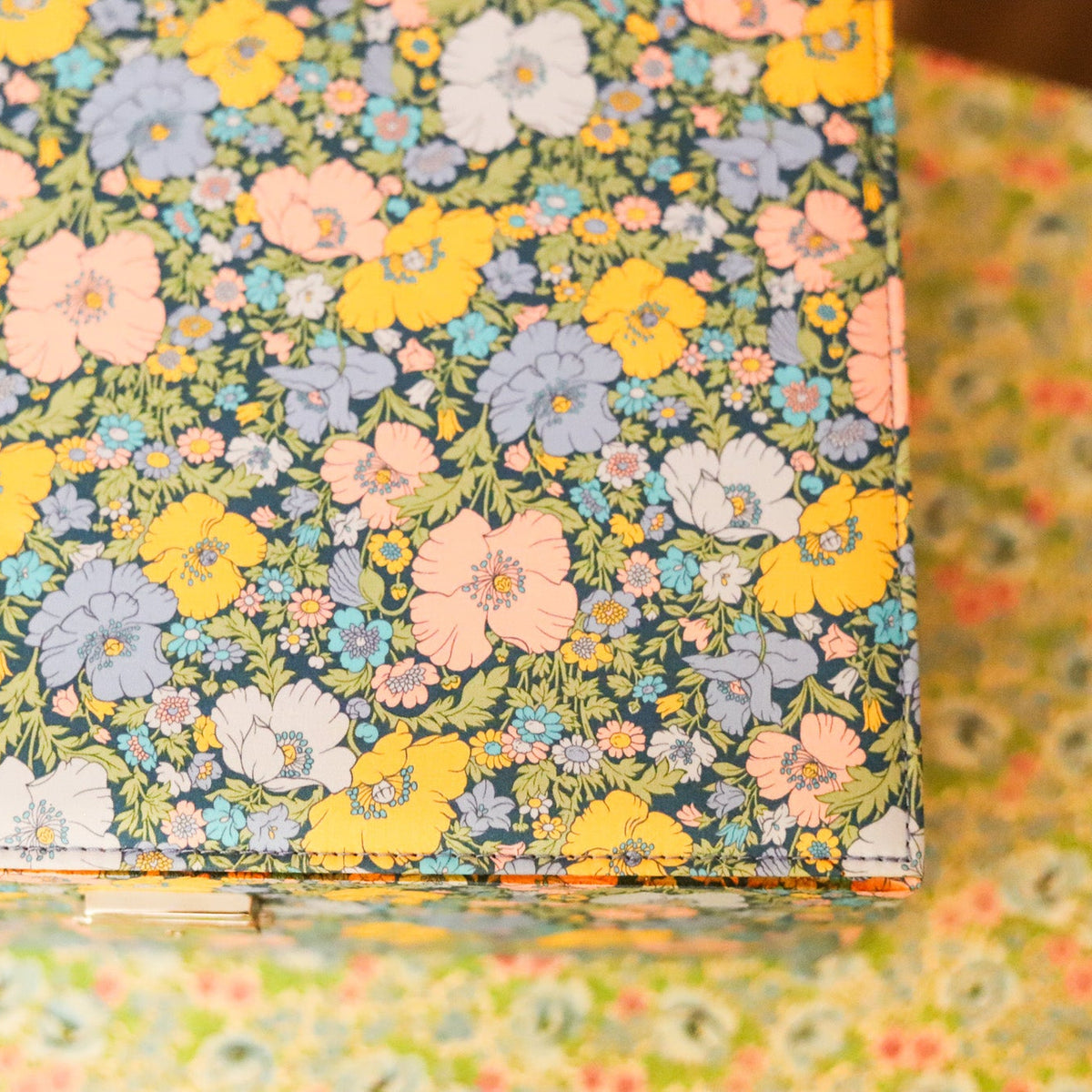 Top your dressing table with this beautiful and practical jewelry box. Fitted with a lock and key and covered in Liberty of London fabric, this jewelry box has an organizational tray that lifts out to reveal additional divided storage. 