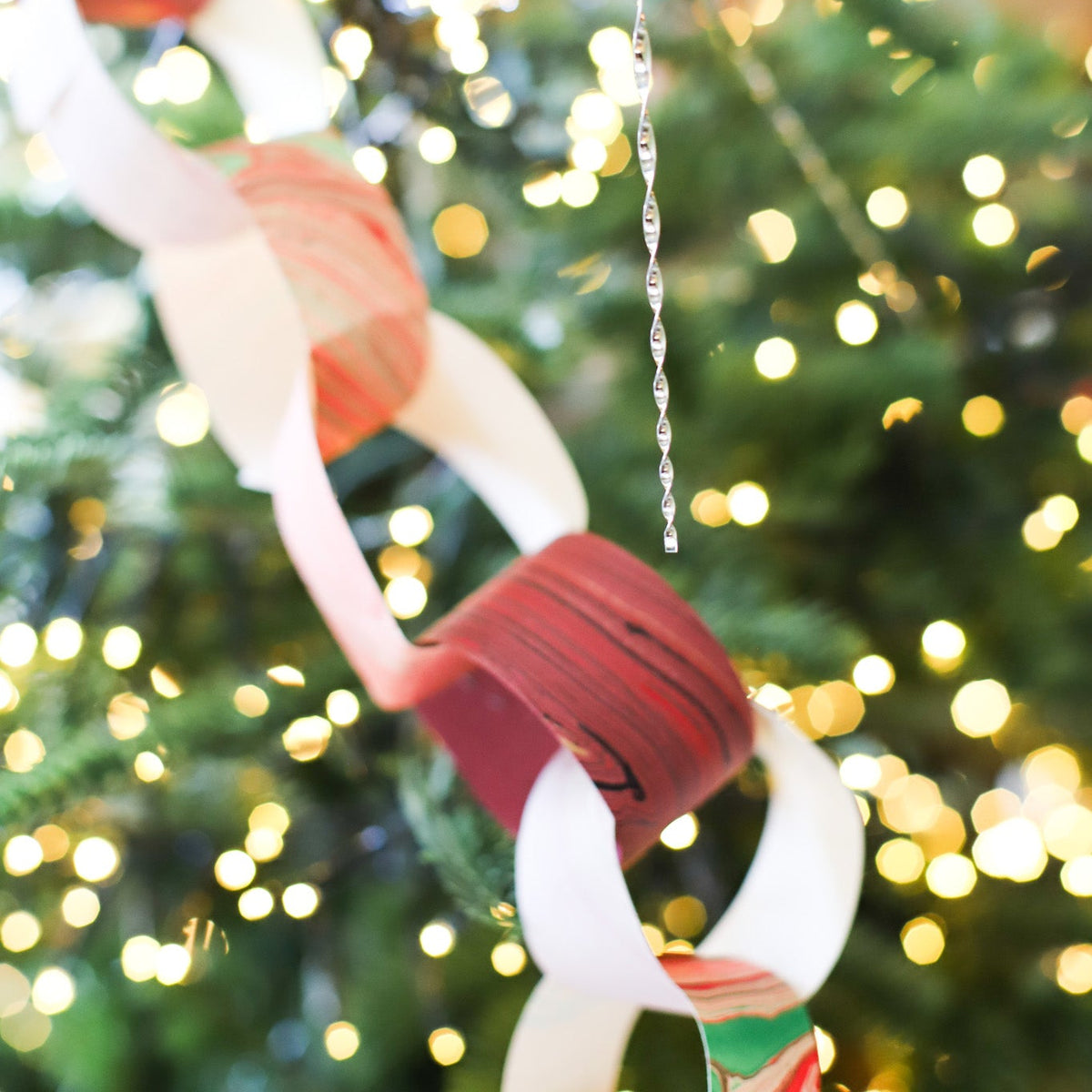 Marbled Paper Chain Kit with colorful pre-cut paper strips for handmade holiday and birthday garland decor.