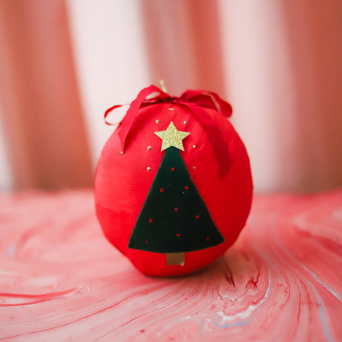 Red Giant Holiday Surprise Ball with Christmas tree detail