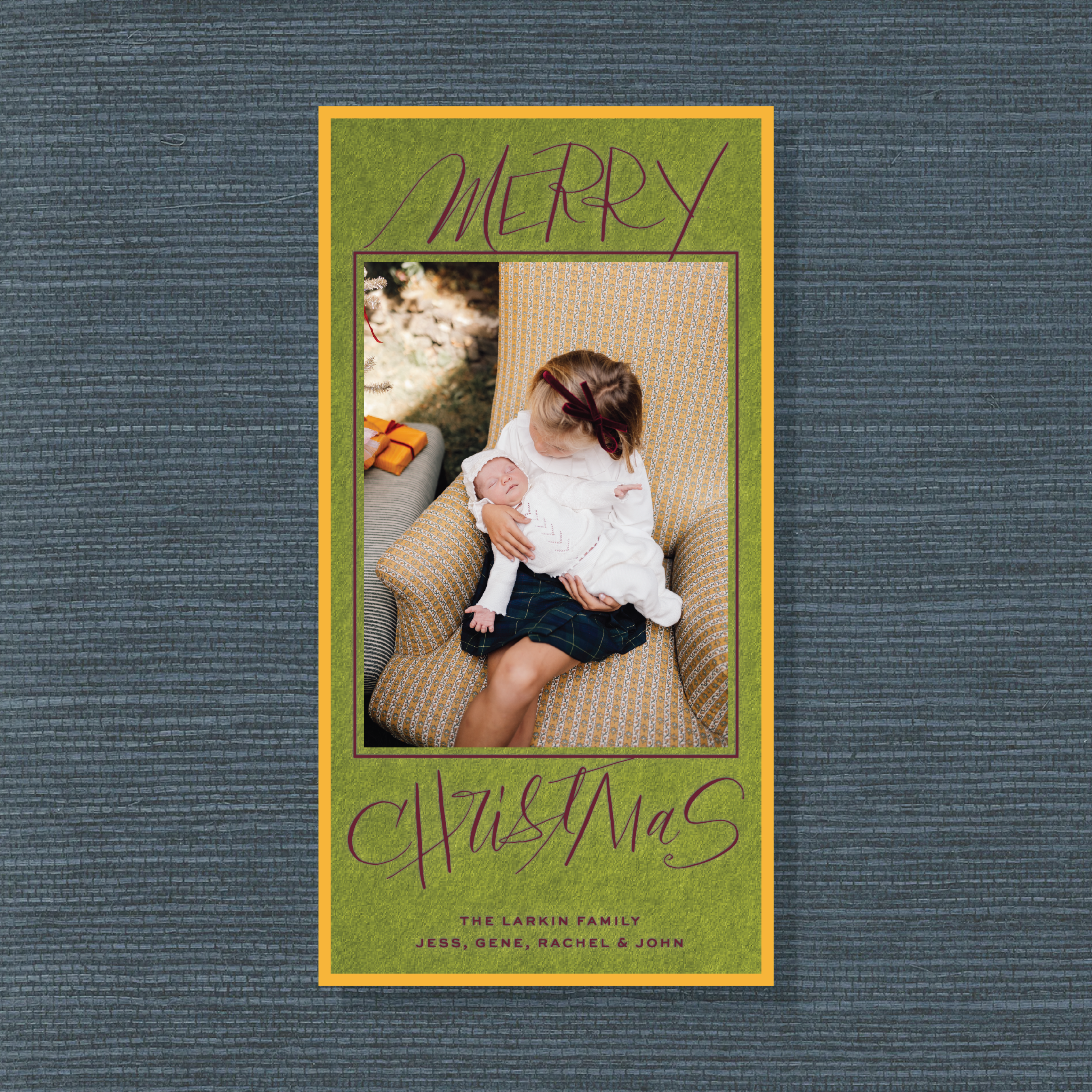Larken Engraved Photo Holiday Card featuring a family photograph, sweeping “Merry Christmas” lettering, and elegant engraved details.
