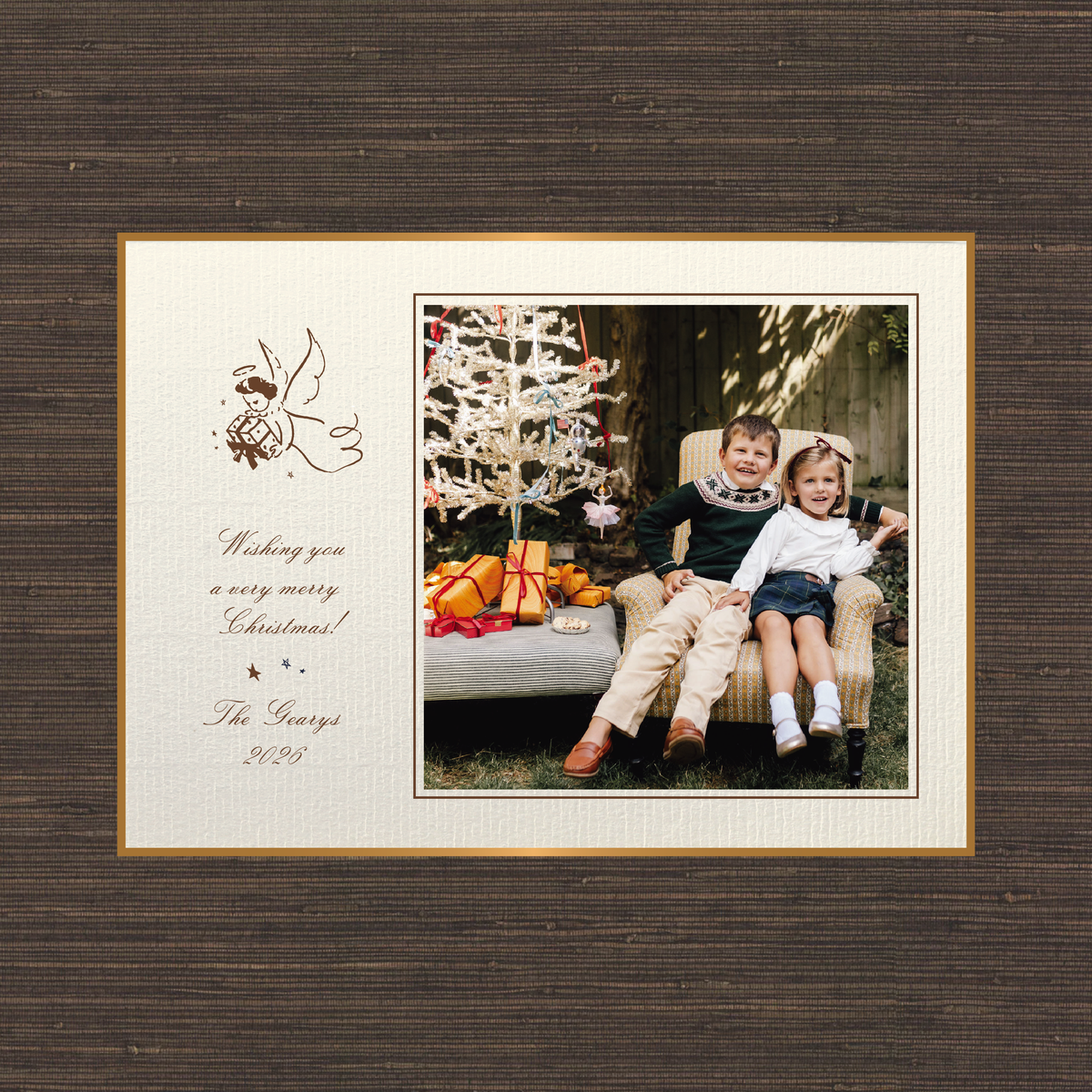 The Sutton personalized photo Christmas card by Stovall Collection, featuring a vintage Christmas angel, classic script typography and a family photograph on creamy laid paper.