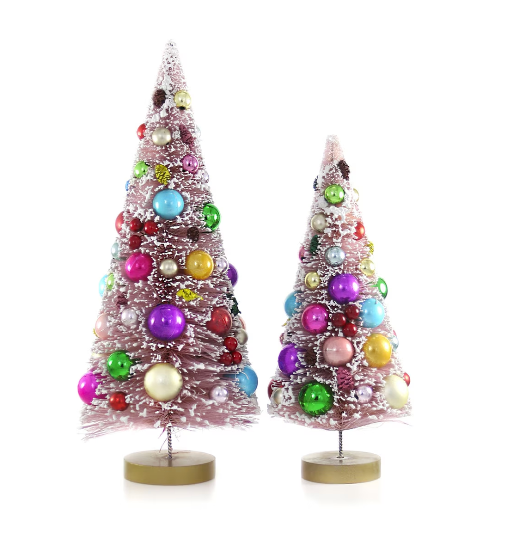 Set of two soft pink bottle brush Christmas trees with colorful baubles, snowy flocking, and gold bases. A playful vintage-inspired holiday accent.