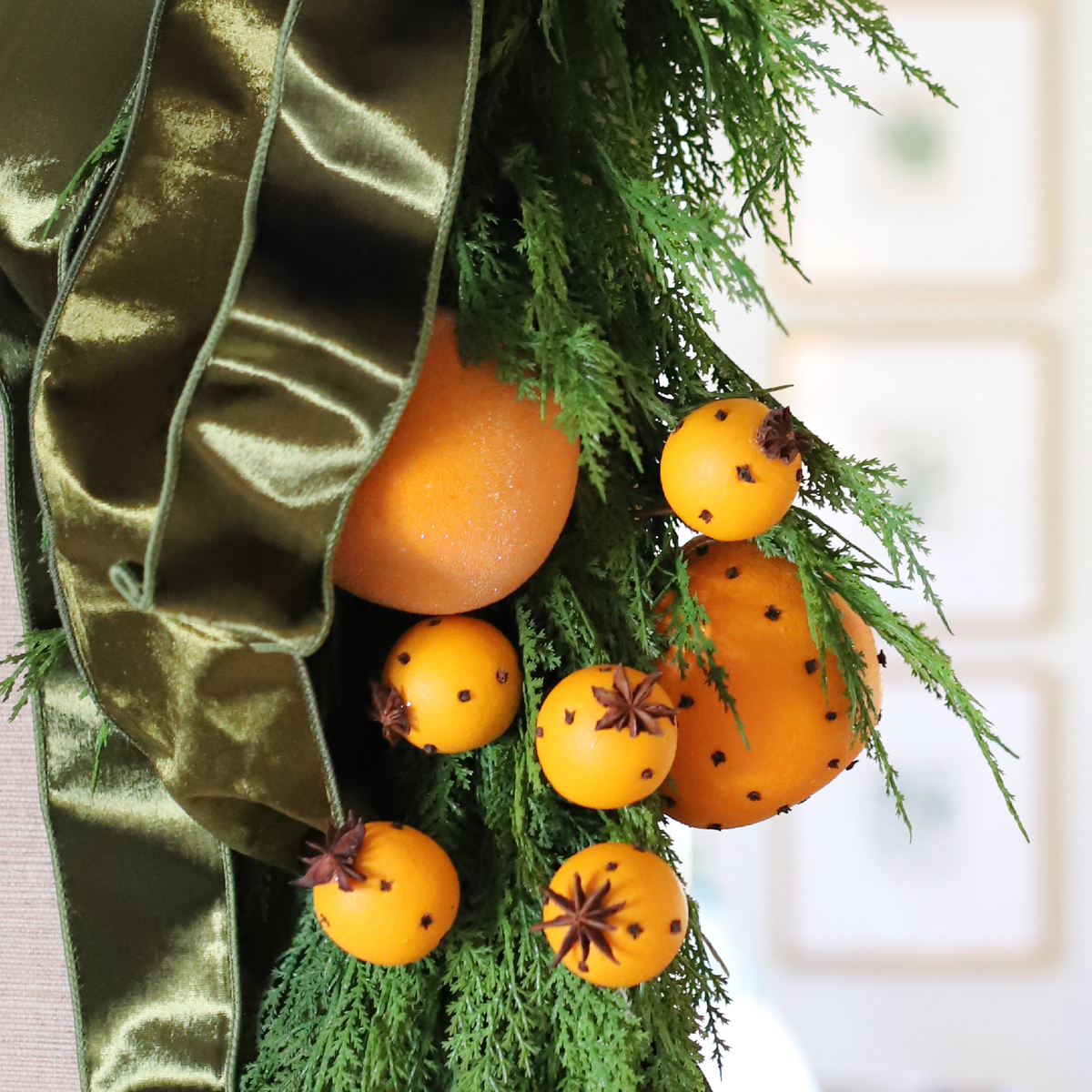 Sugared Seville Orange Ornaments styled with pomanders, Hampshire greenery, and olive velvet ribbon