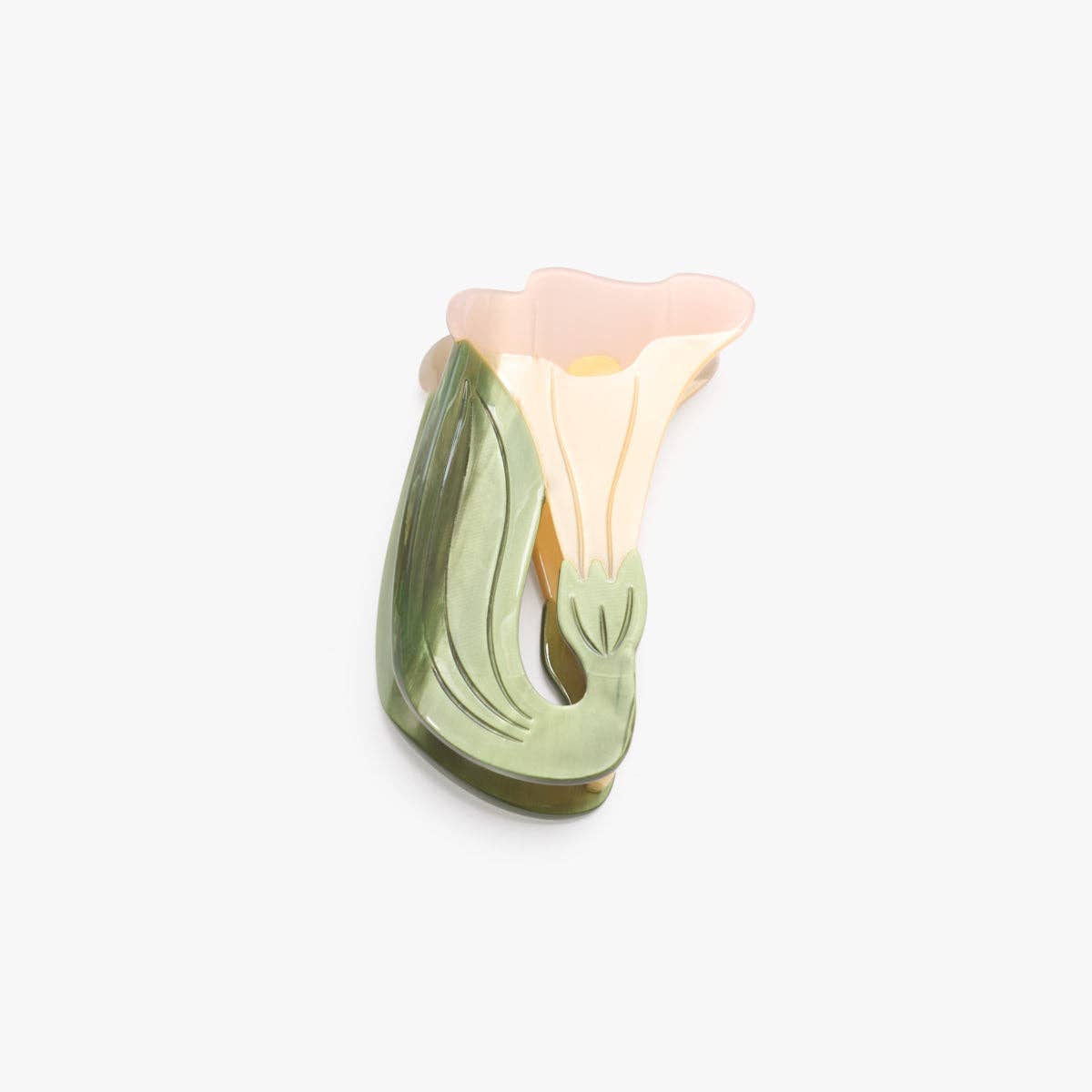 The White Iris Hair Clip features soft ivory petals and layered green leaves, handcrafted from cellulose acetate for an elegant botanical statement.