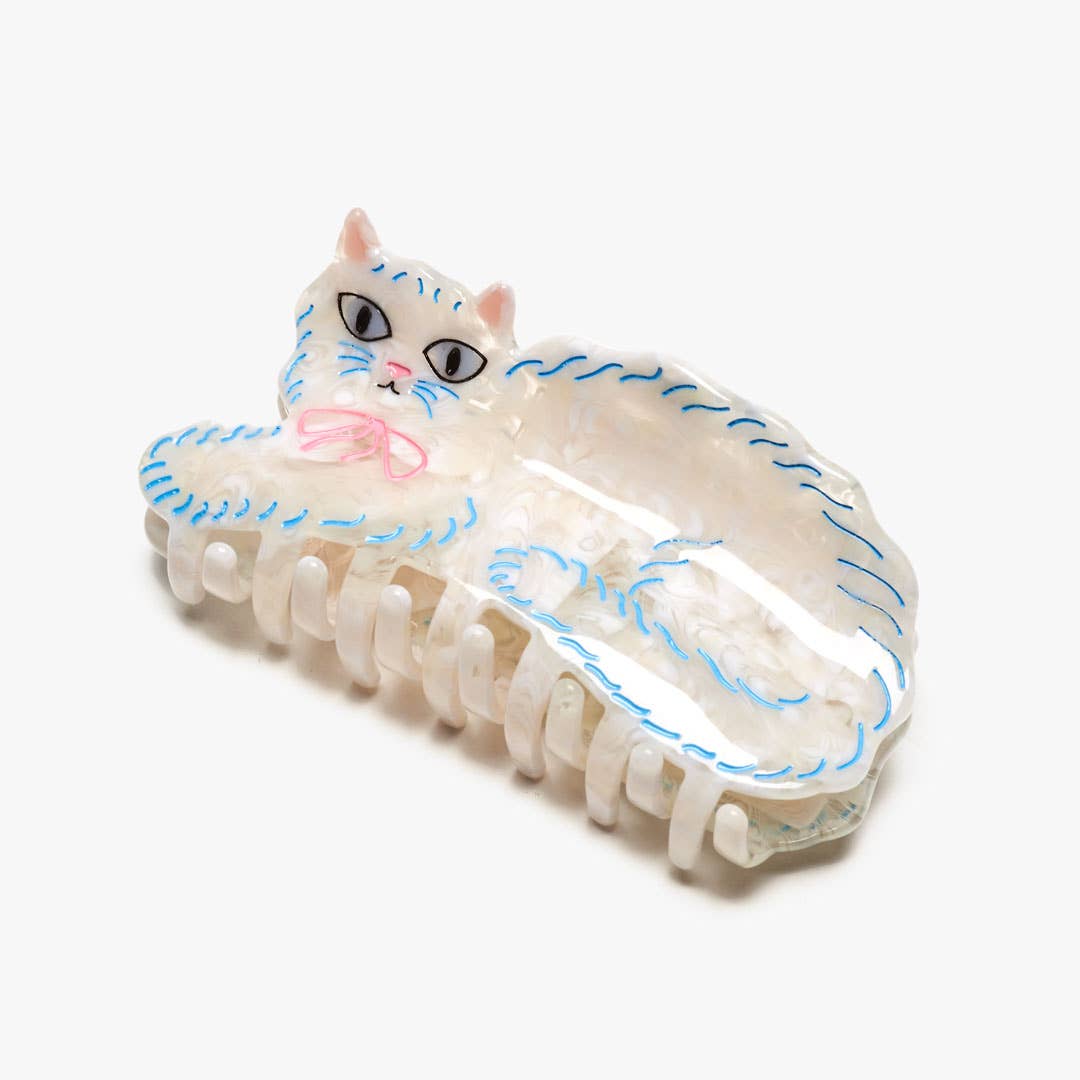 The Pretty Kitty Hair Claw features a fluffy white Persian cat design with hand-painted details, crafted from glossy cellulose acetate.