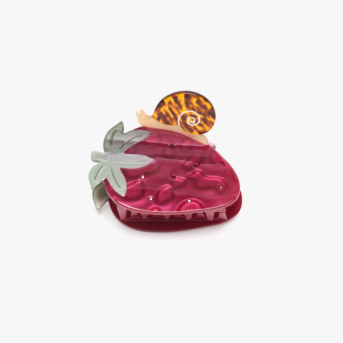 The Strawberry Snail Hair Claw features a glossy red strawberry with green leaves and a tiny tortoise shell snail, crafted from cellulose acetate.