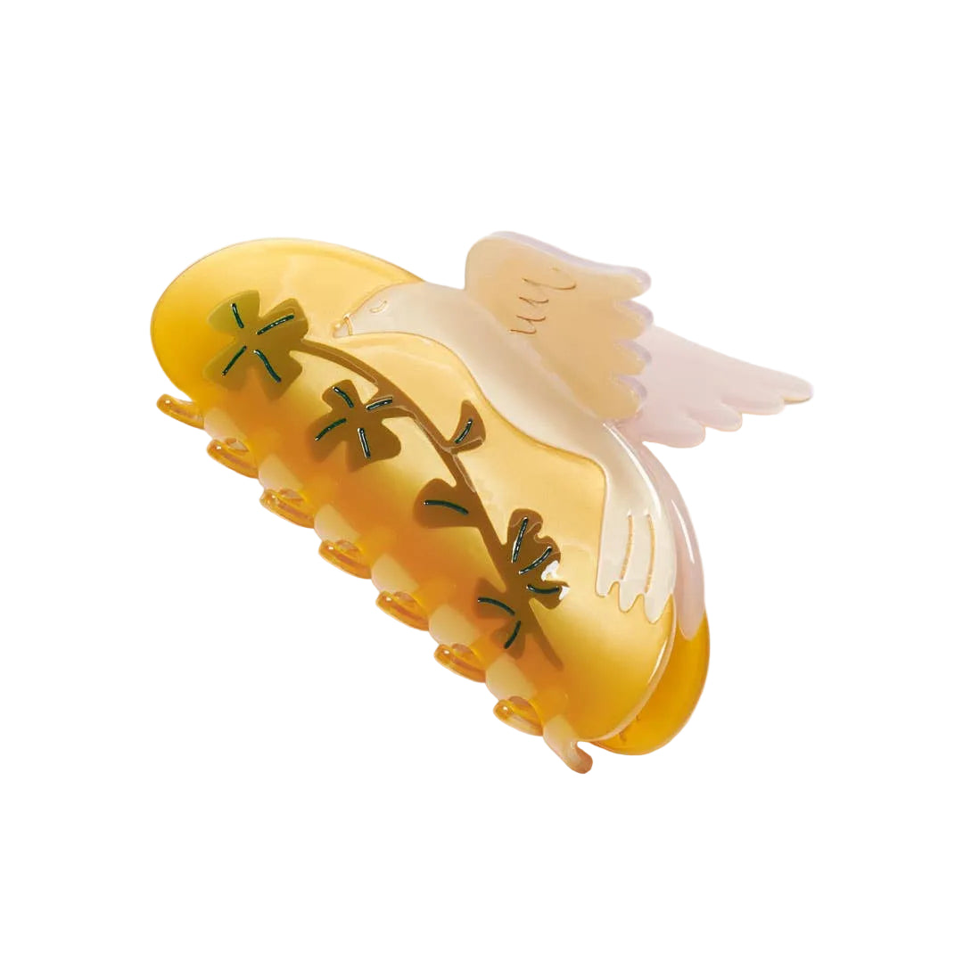 The Lucky Dove Hair Claw features a graceful bird design with golden, blush and botanical details, crafted from individually cut cellulose acetate.