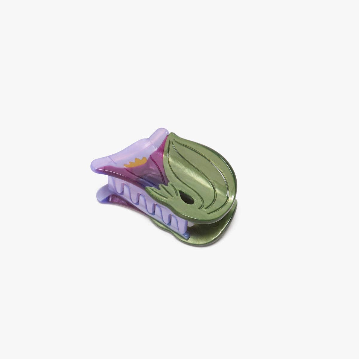 The Morning Glory Hair Claw features a delicate purple bloom and leafy green details, crafted from cellulose acetate for a petite floral statement.