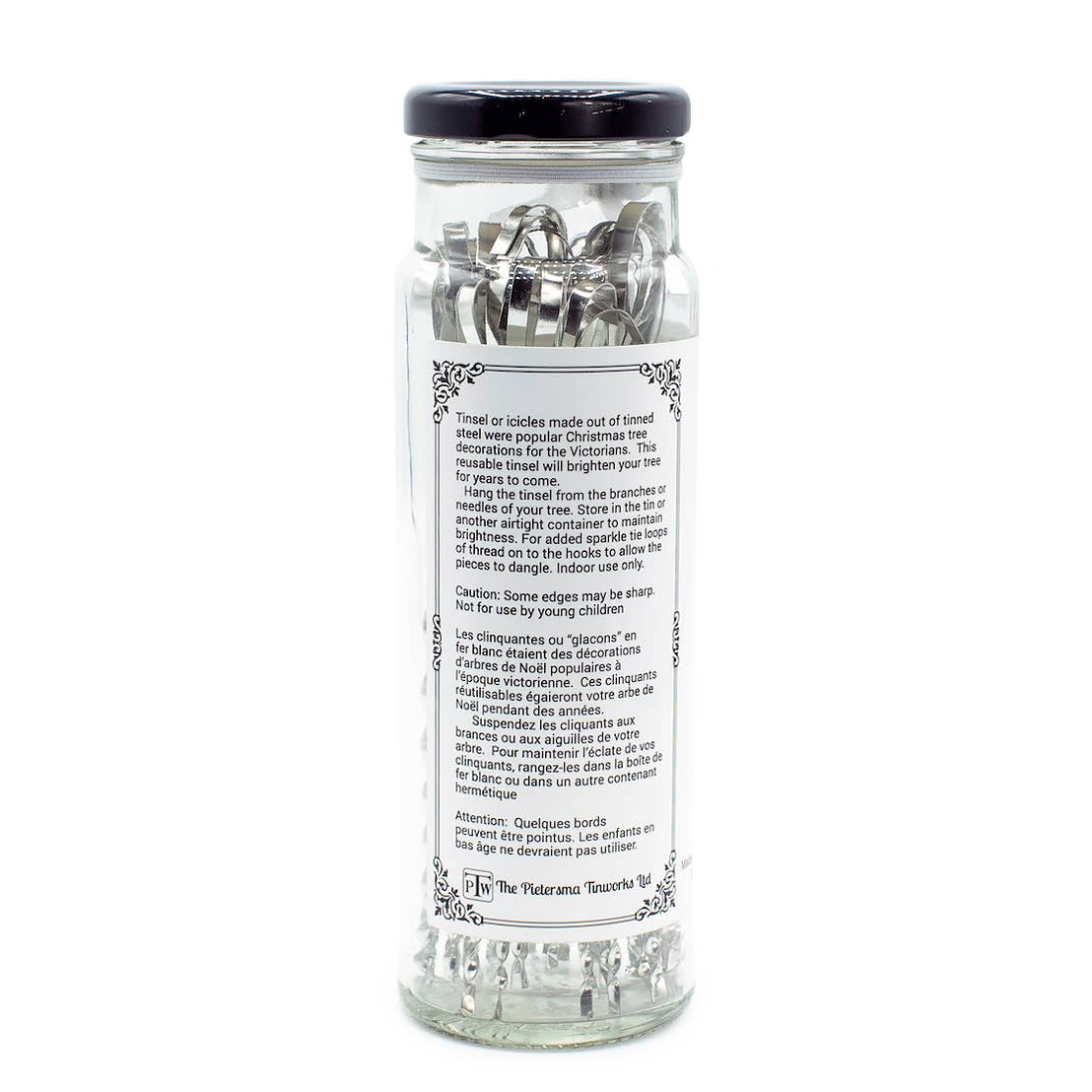 Glass bottle filled with reusable Victorian Christmas Tree Tinsel made from silver tin-plated steel