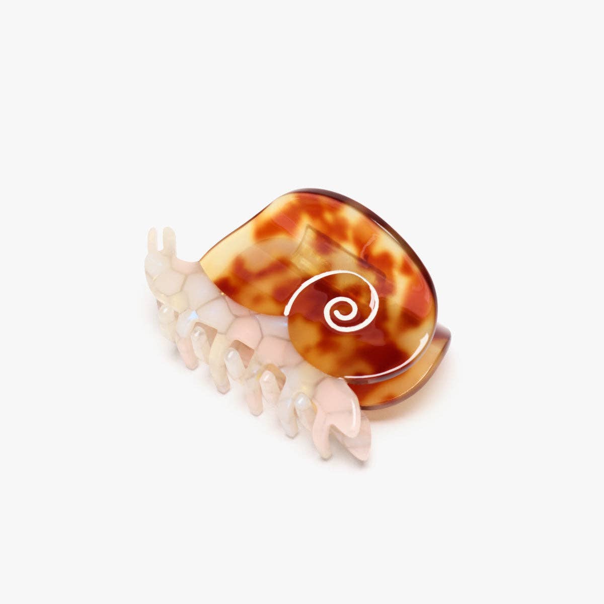 The Sea Snail Hair Claw features a pearlescent body and amber tortoise shell, crafted from individually cut cellulose acetate for a playful statement.
