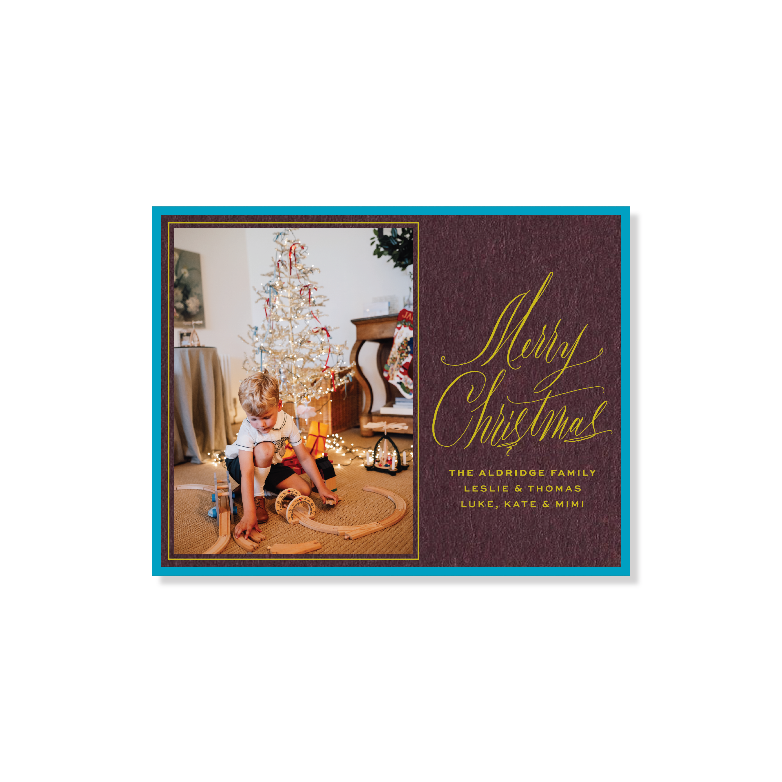 Aldridge Engraved Christmas Photo Card featuring a family photograph beside hand-lettered “Merry Christmas” calligraphy on a rich red background with personalized family names.