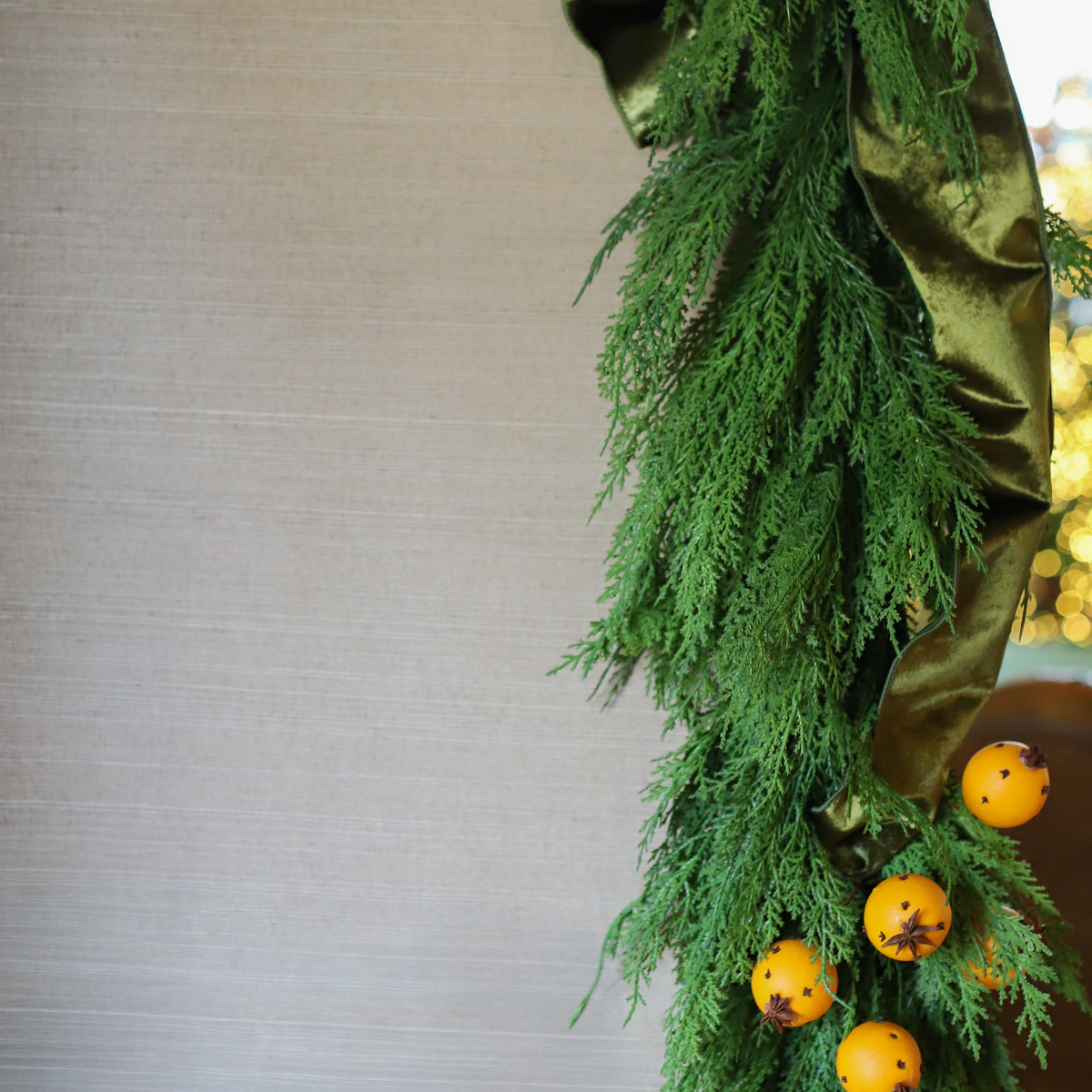 Hampshire faux cedar Christmas garland decorated with oranges and green velvet ribbon