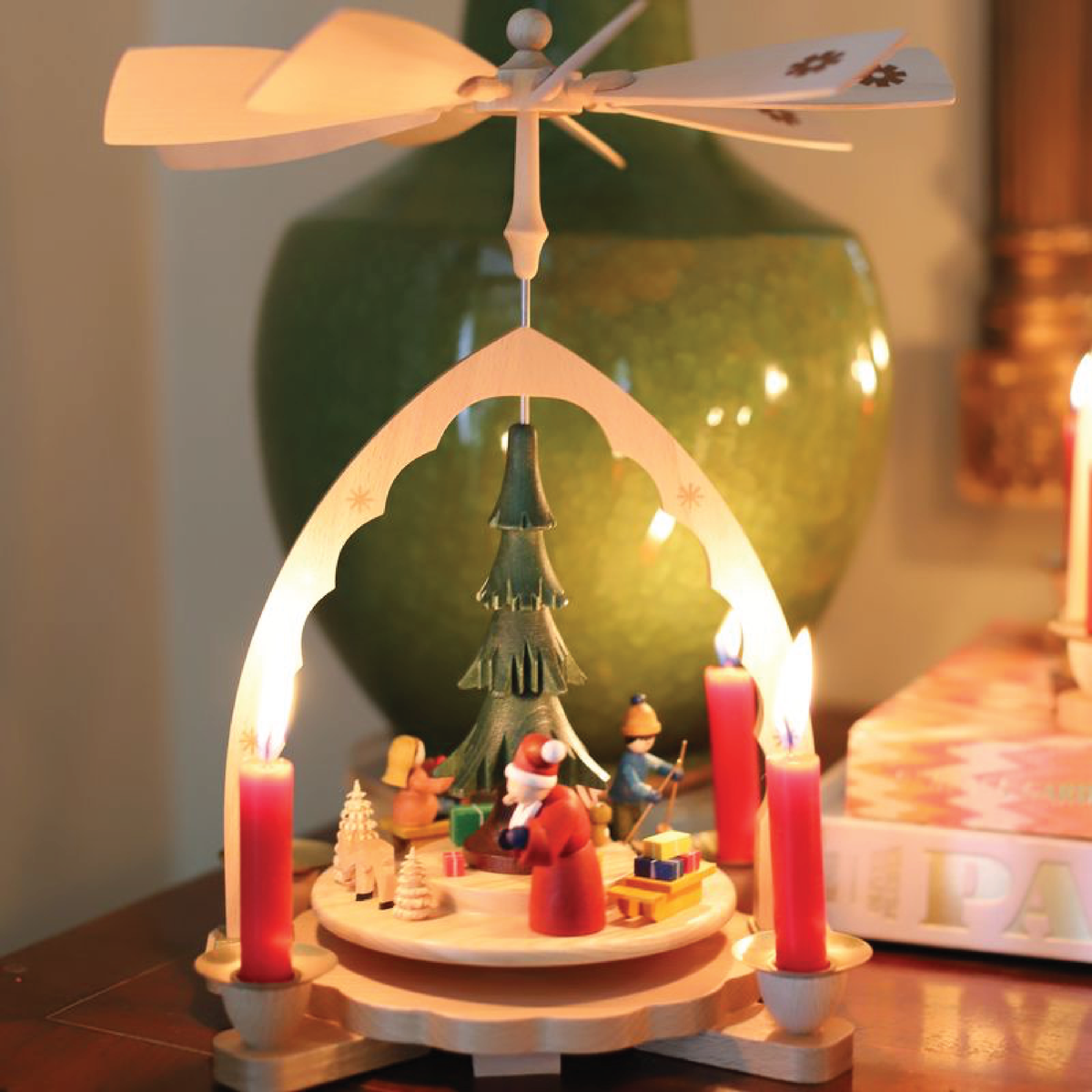 Christmas Morning Magic German wooden Christmas pyramid featuring Santa, children, colorful toys, and a traditional candle-powered rotating fan.