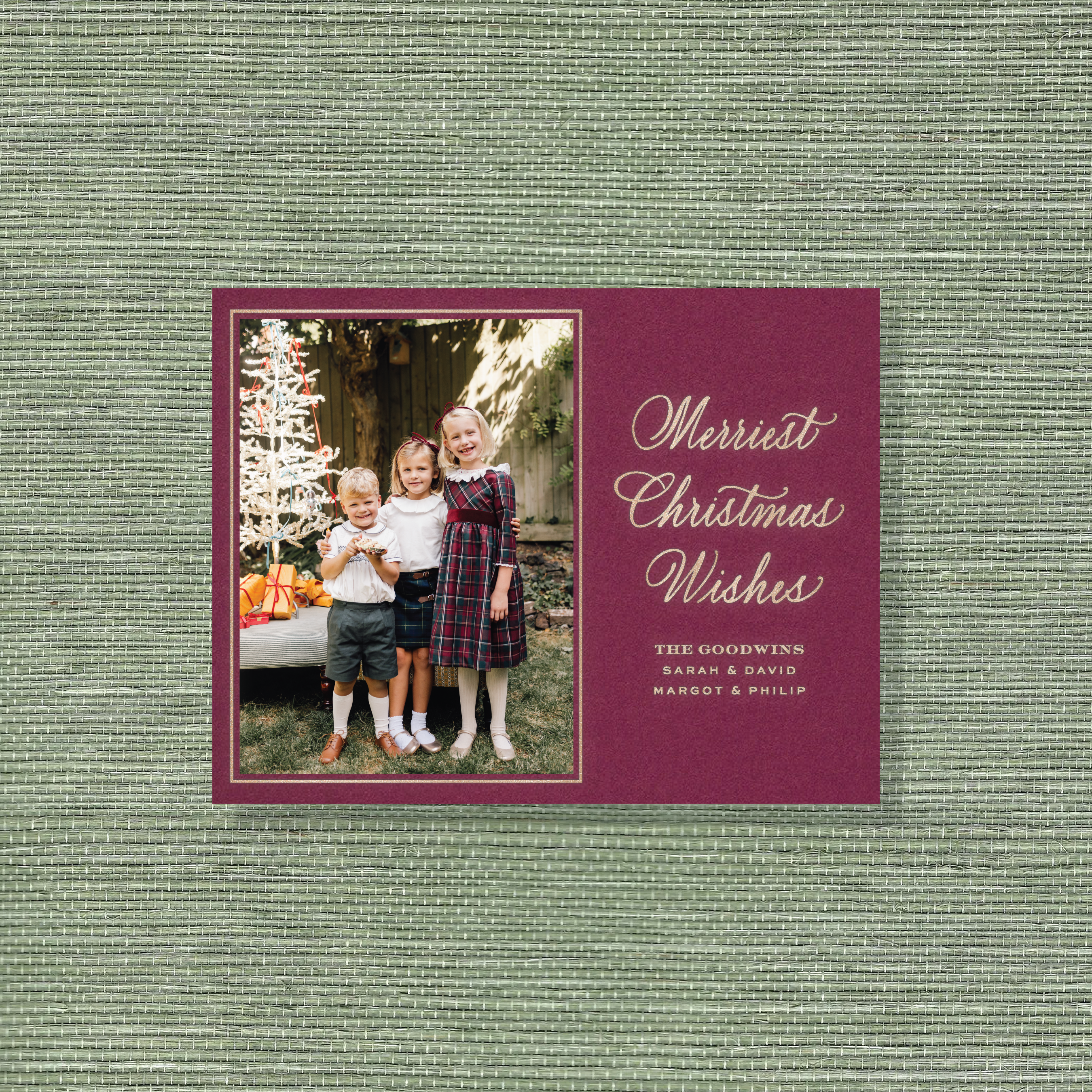 Goodwin Engraved Christmas Photo Card with a vertical family photo, graceful holiday calligraphy, and crisp raised engraved details.