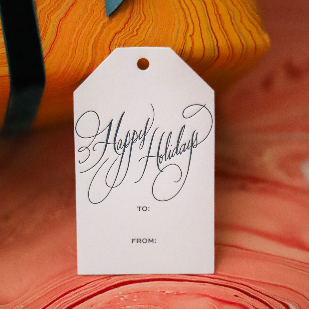 Shop Happy Holidays Gift Tags in sets of 8, featuring elegant hand-lettered lettering, To and From lines, and coordinating color options for festive gift wrapping.