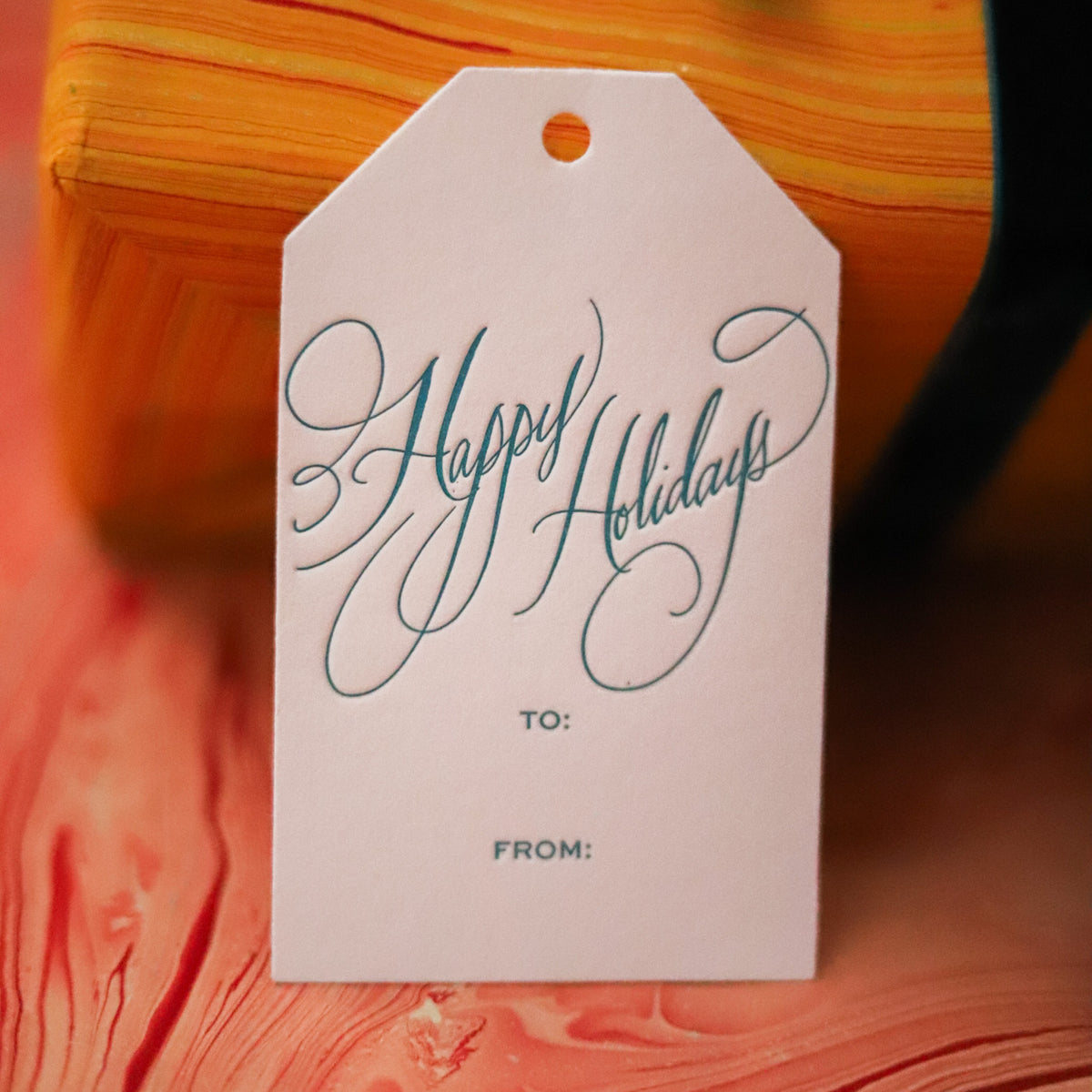 Shop Happy Holidays Gift Tags in sets of 8, featuring elegant hand-lettered lettering, To and From lines, and coordinating color options for festive gift wrapping.