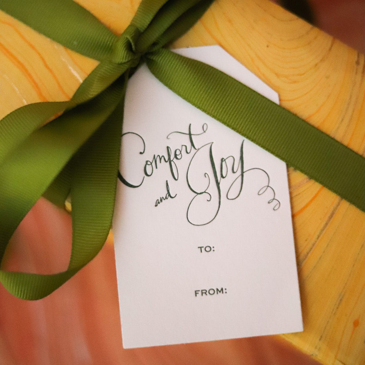 Shop Comfort & Joy Gift Tags in sets of 8, featuring hand-lettered lettering, To and From lines, and coordinating colors for festive Christmas wrapping.