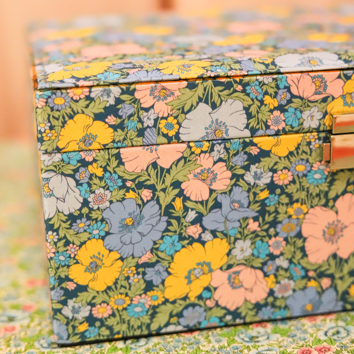 Top your dressing table with this beautiful and practical jewelry box. Fitted with a lock and key and covered in Liberty of London fabric, this jewelry box has an organizational tray that lifts out to reveal additional divided storage.&nbsp;&nbsp;