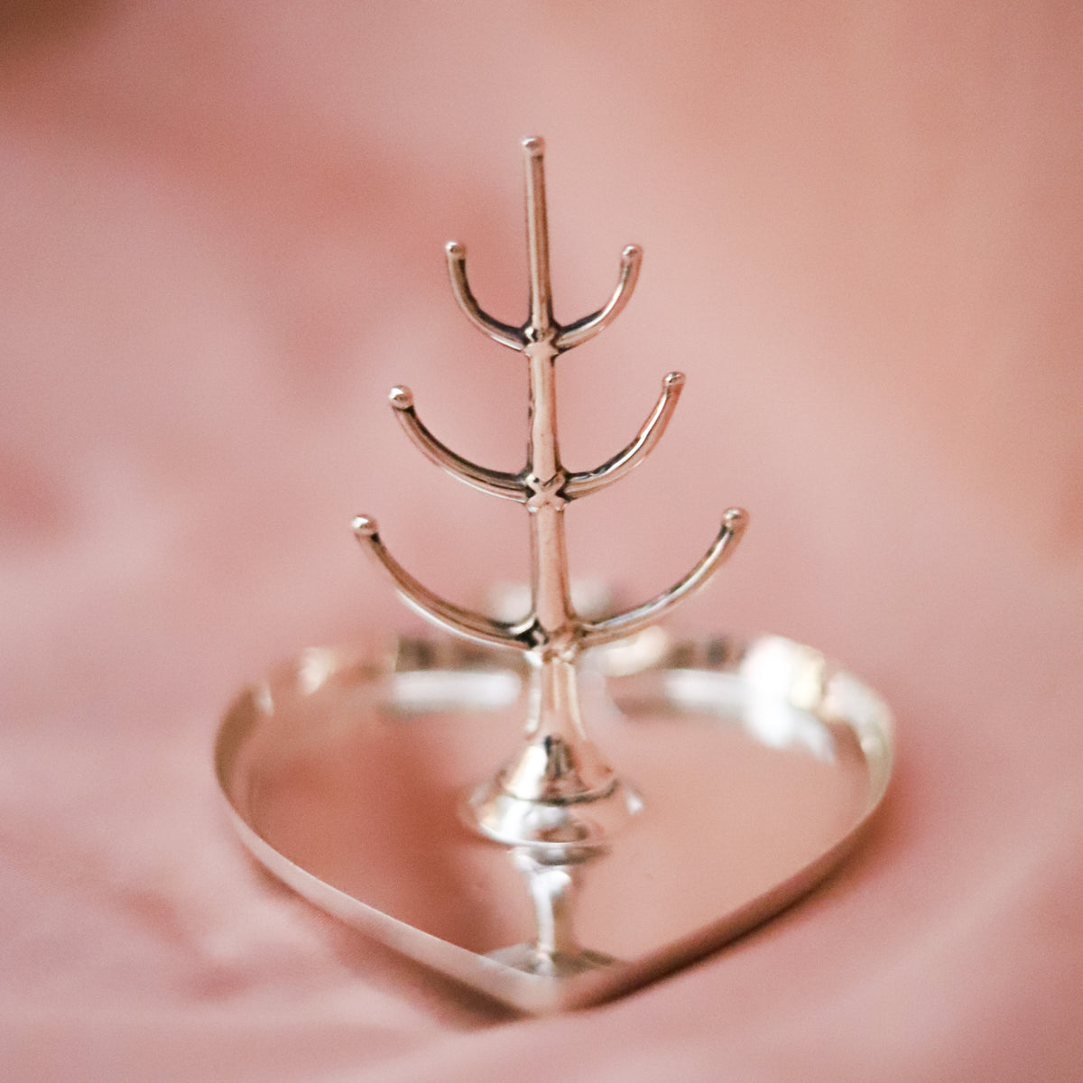 This antique sterling silver ring tree was made in Birmingham, England and hallmarked in 1921, during the reign of King George V.