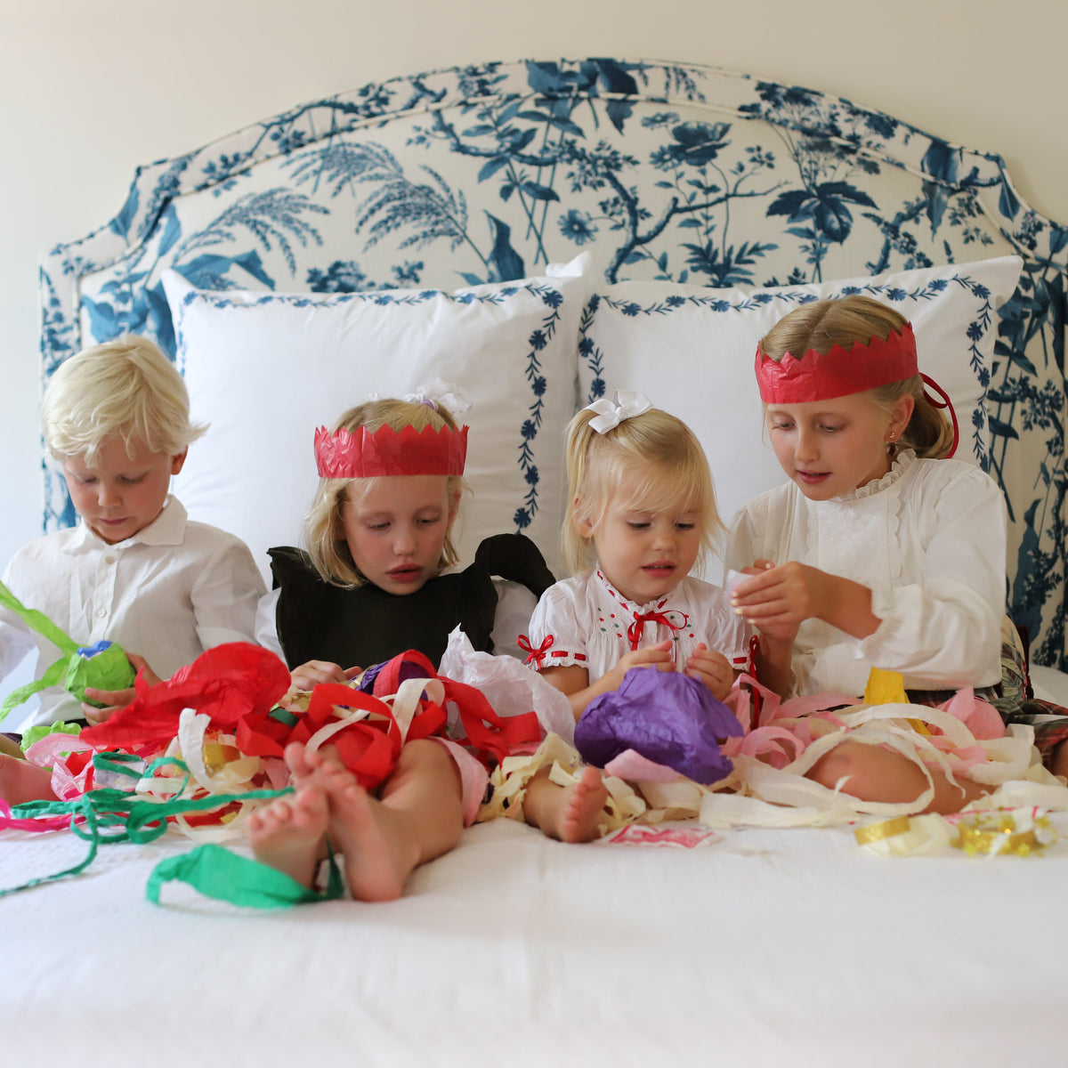 Children opening colorful Surprise Balls and unwinding layers of crepe pape