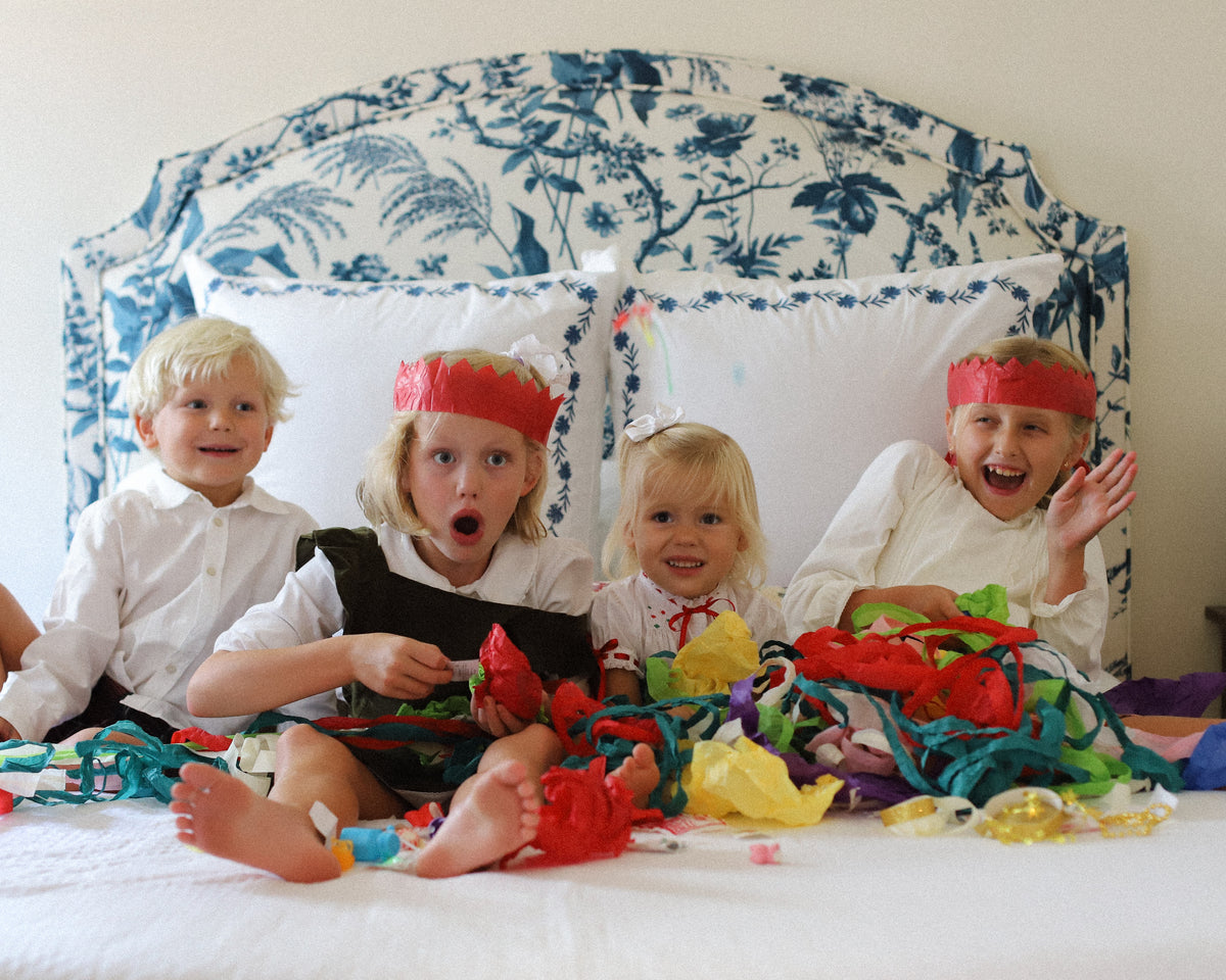 Children opening colorful Holiday Surprise Balls and discovering Christmas surprises inside