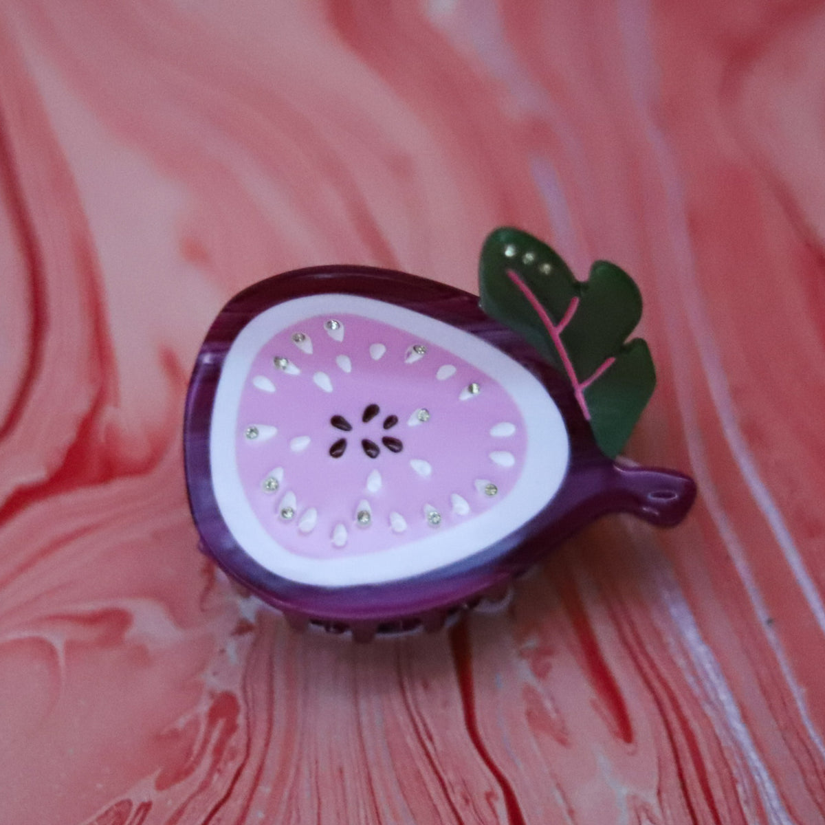 Add a playful touch with the Sweet Fig Hair Claw, handmade from cellulose acetate with rich plum, pink and green fig details and a secure medium-size grip.