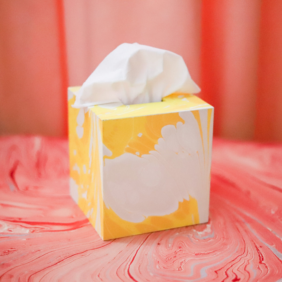 Elevate an everyday essential with our handmade marbled tissue box cover, crafted from unique papers sourced around the world. Each piece is one of a kind.