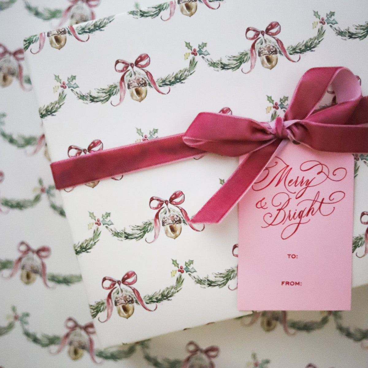 Wrap holiday gifts in nostalgic charm with our Christmas Bell Garland Gift Wrap, featuring watercolor bells, bows and greenery on soft cream. 20" x 30".