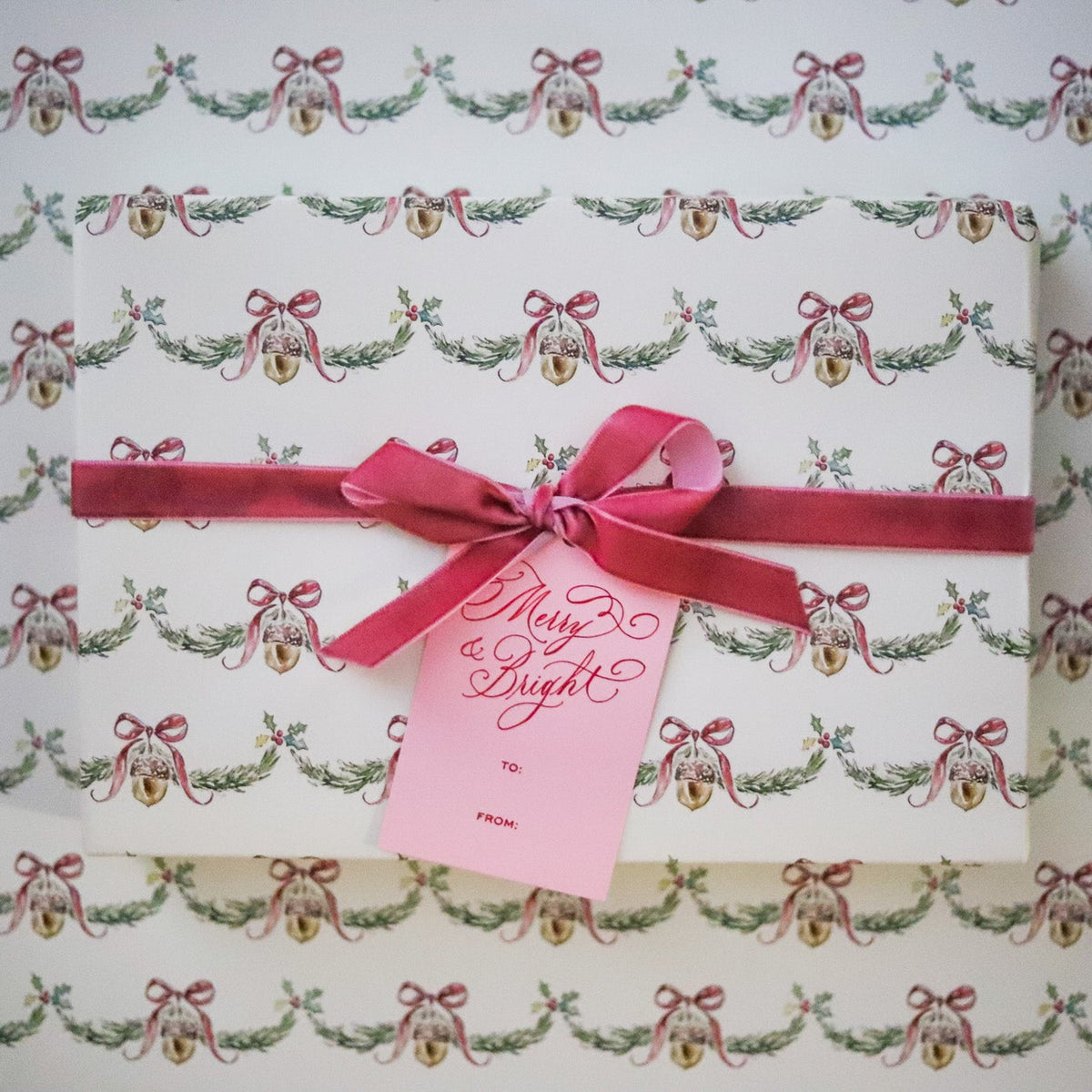 Wrap holiday gifts in nostalgic charm with our Christmas Bell Garland Gift Wrap, featuring watercolor bells, bows and greenery on soft cream. 20" x 30".