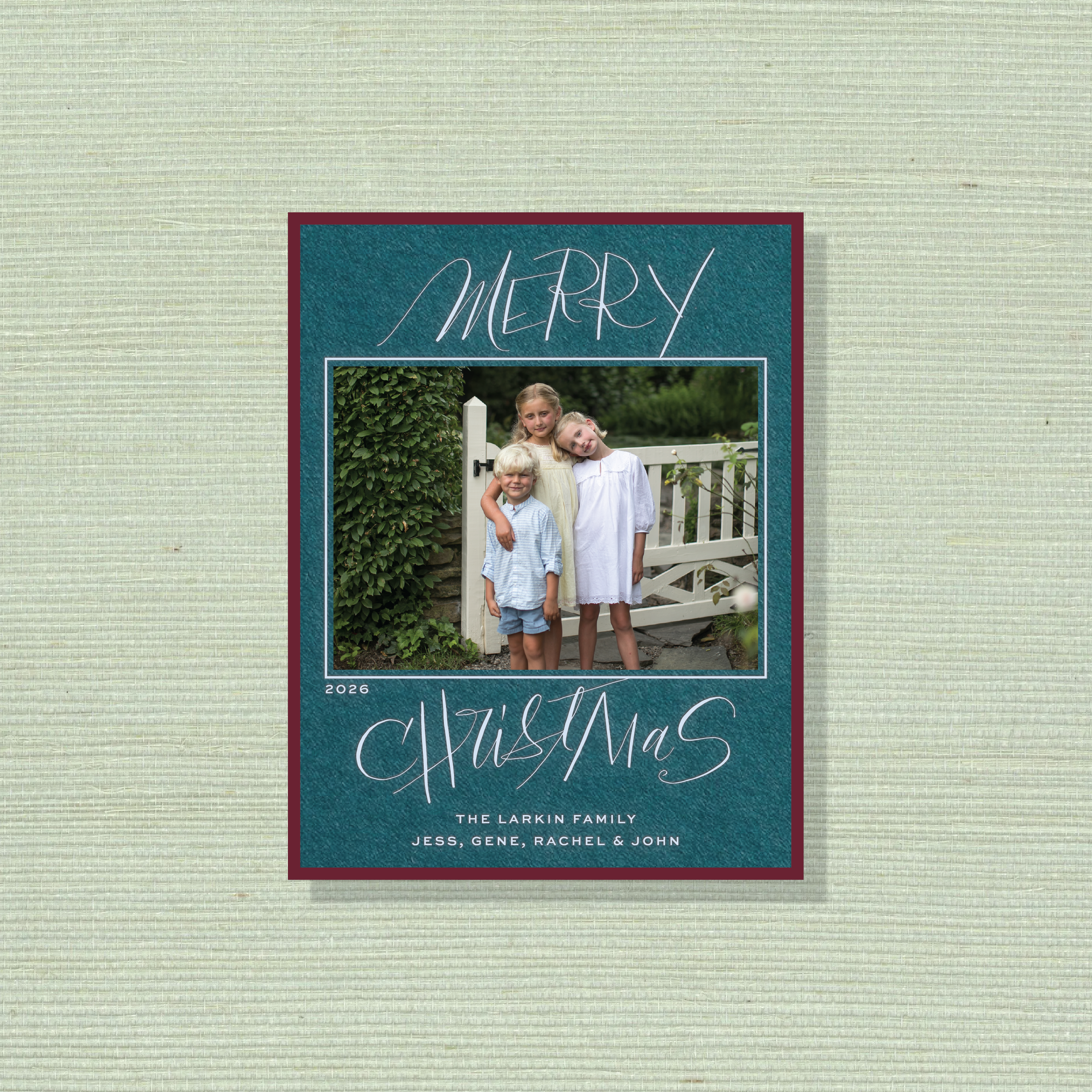 Larken Engraved Holiday Card featuring sweeping hand-lettered “Merry Christmas” calligraphy, a family photograph, and traditional engraving.