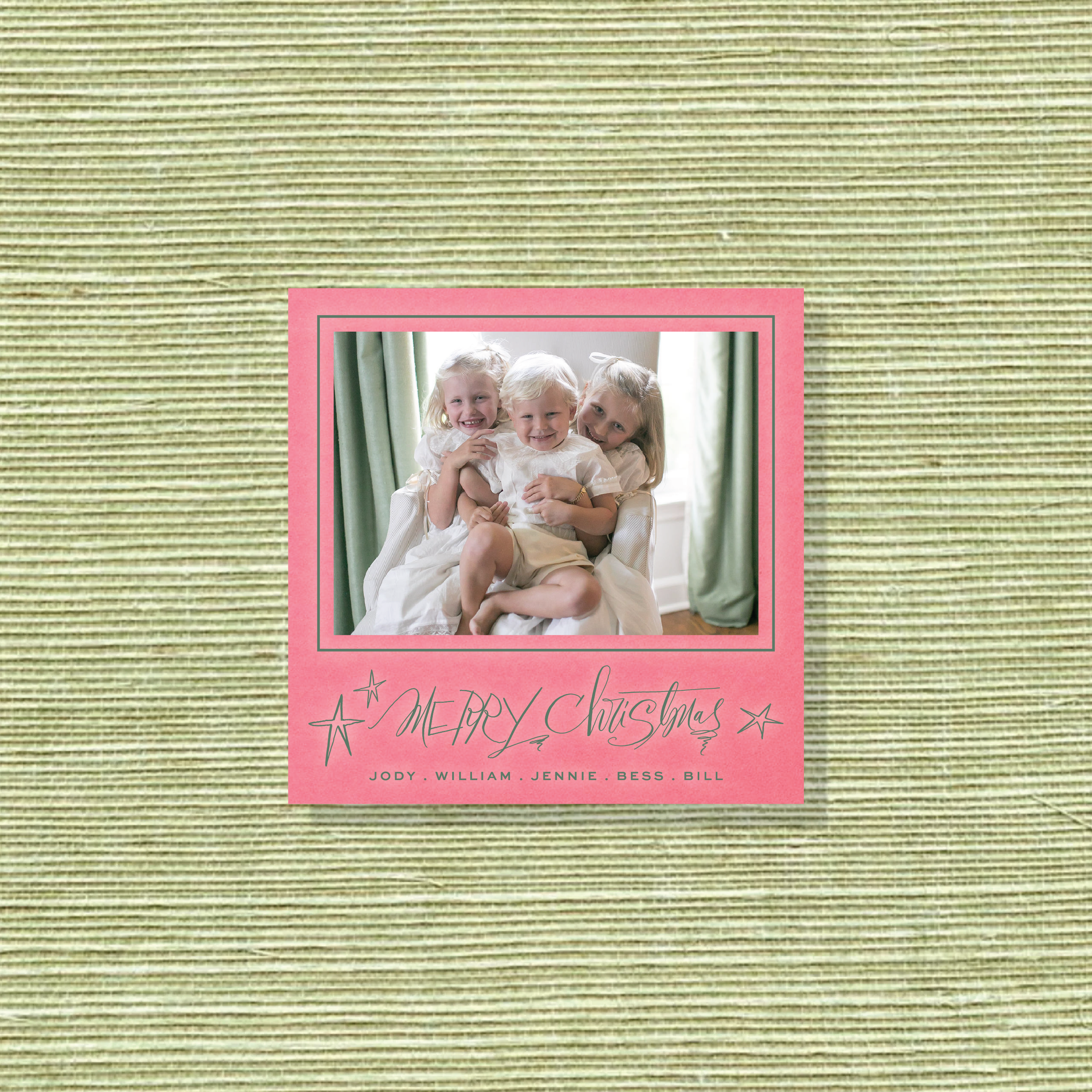 Merritt Engraved Christmas Photo Card with a family portrait, playful “Merry Christmas” lettering, and crisp raised engraved details.