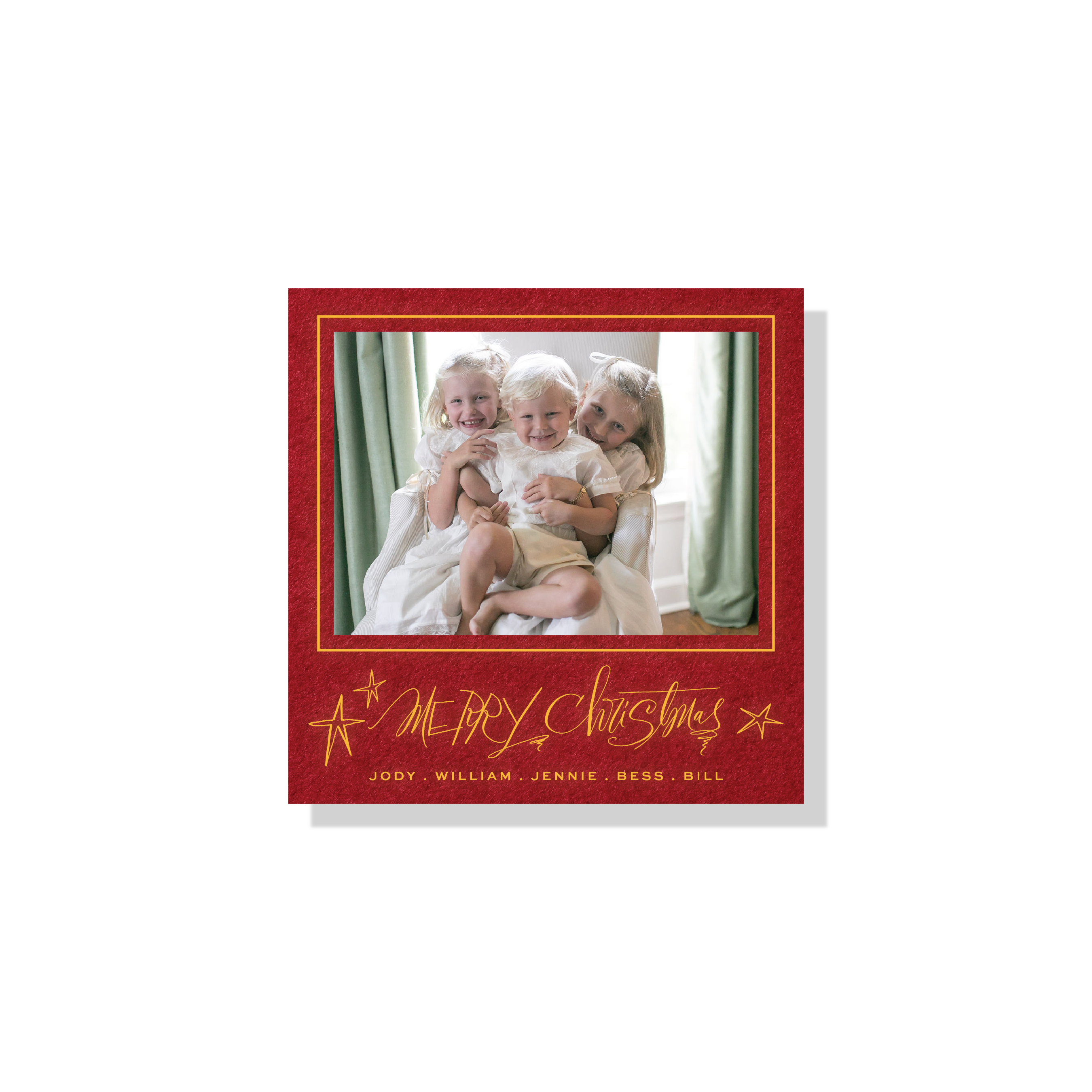 Merritt Engraved Christmas Photo Card with a family portrait, playful “Merry Christmas” lettering, and crisp raised engraved details.