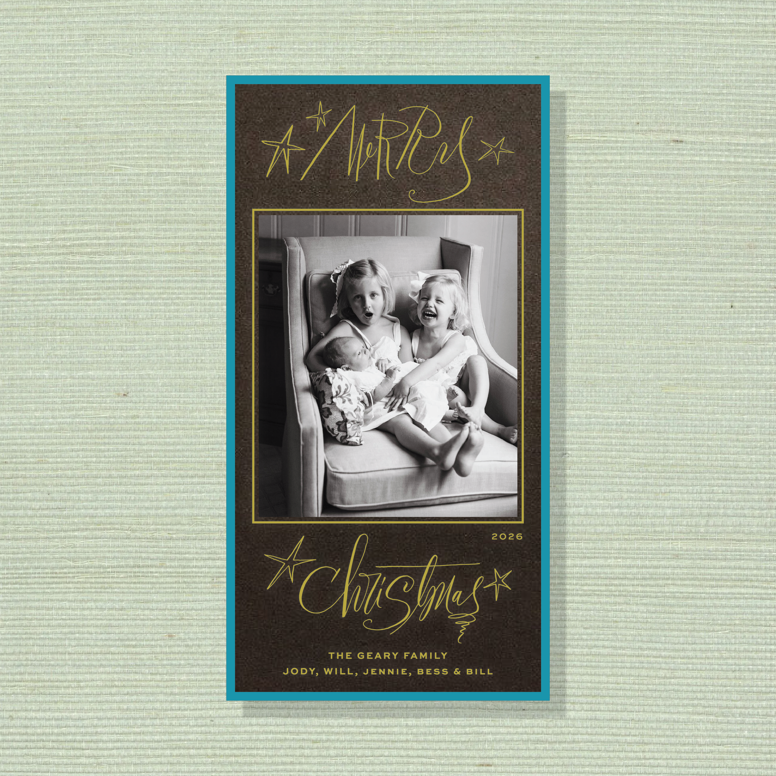 Merritt Engraved Photo Holiday Card featuring a family photograph, joyful “Merry Christmas” lettering, and elegant engraved details