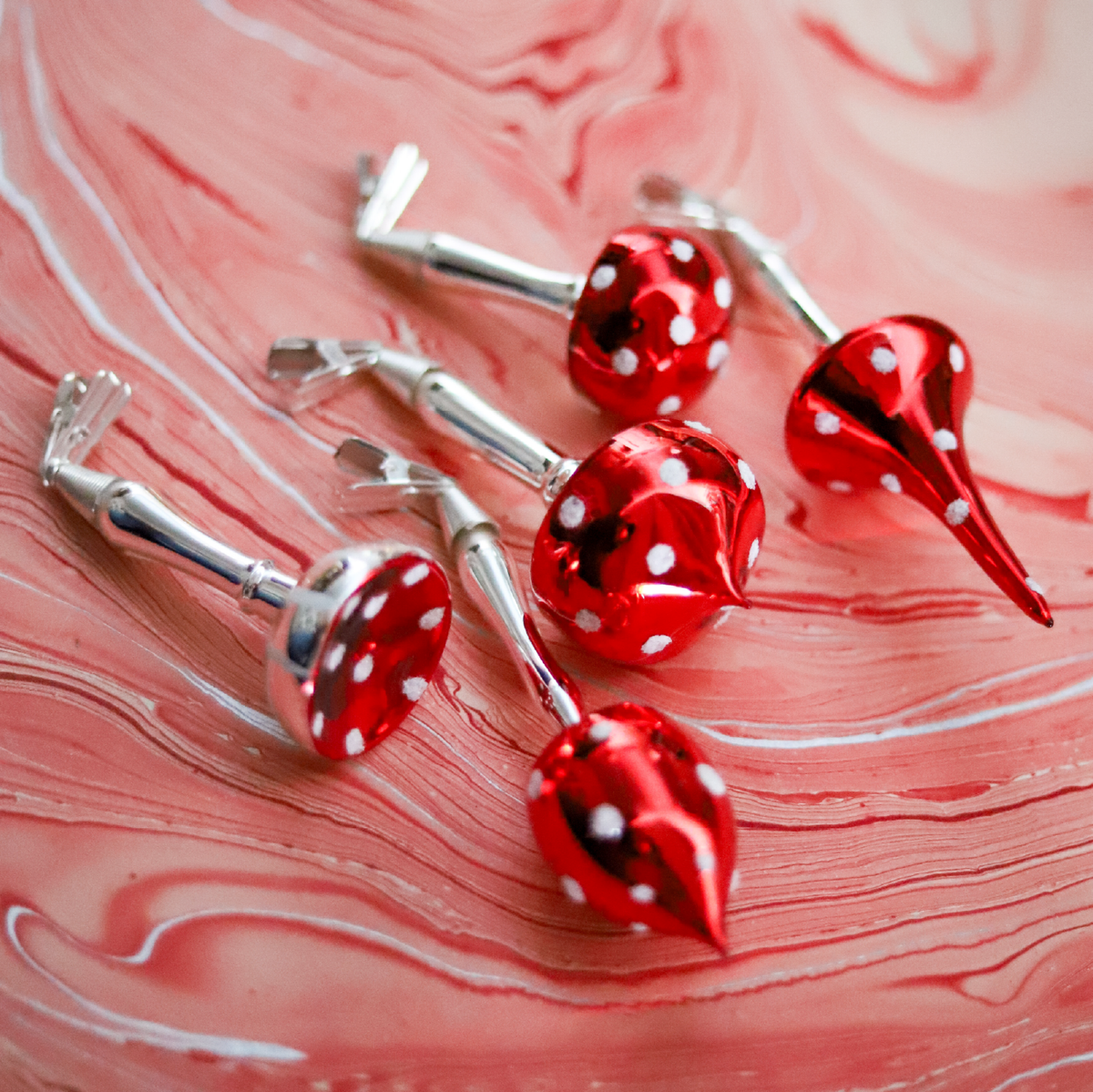 Made in Europe and blown and painted by hand, these glass mushroom clip ornaments bring old-world charm and storybook detail to the Christmas tree.