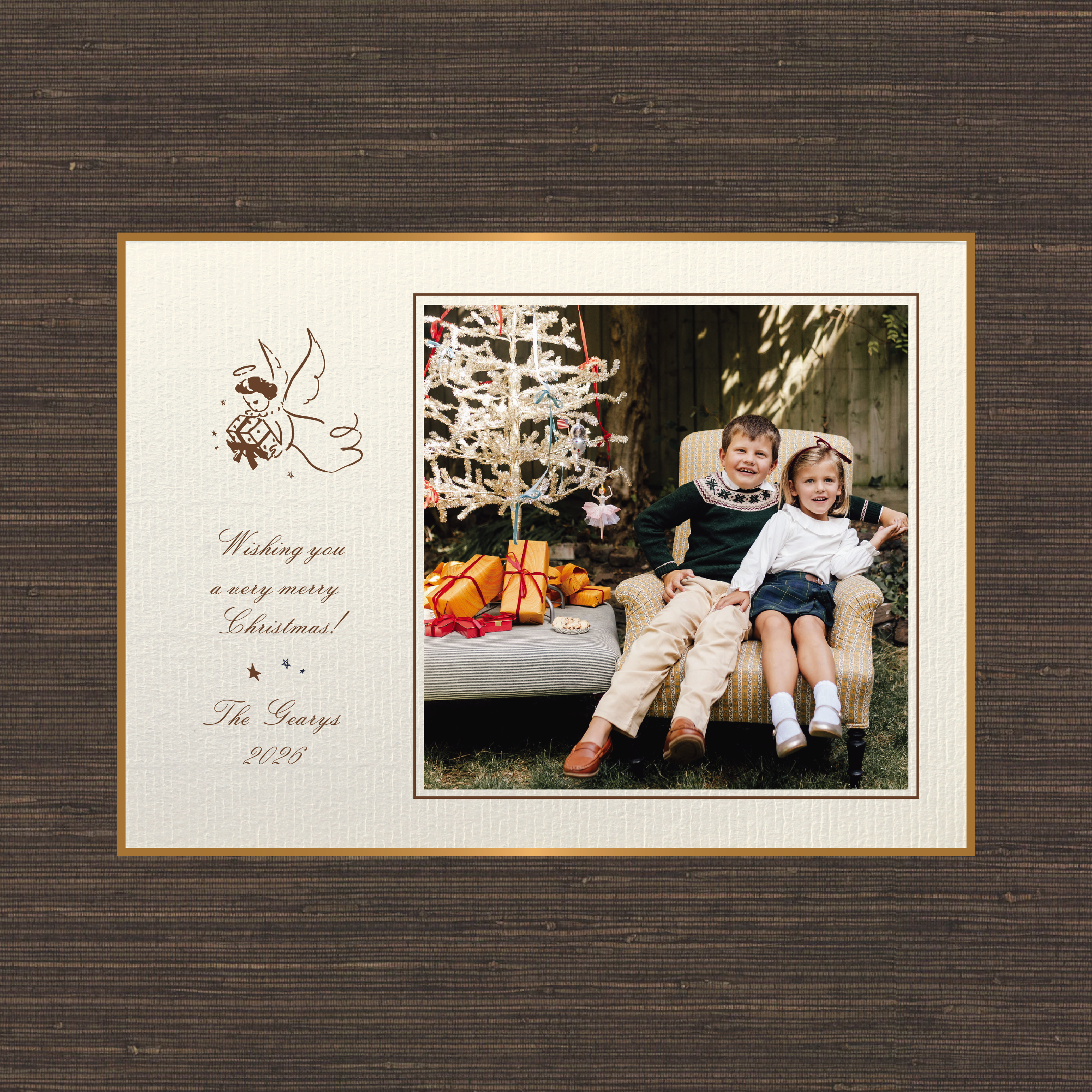 The Sutton personalized photo Christmas card by Stovall Collection, featuring a vintage Christmas angel, classic script typography and a family photograph on creamy laid paper.