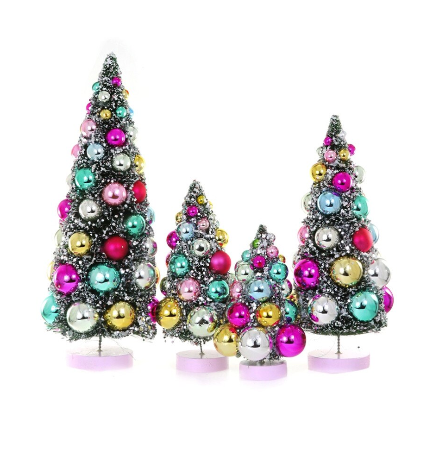 Colorful bauble bottle brush Christmas trees with snowy flocking and shimmering ornaments. A festive accent for mantels, villages, tablescapes, and holiday displays.