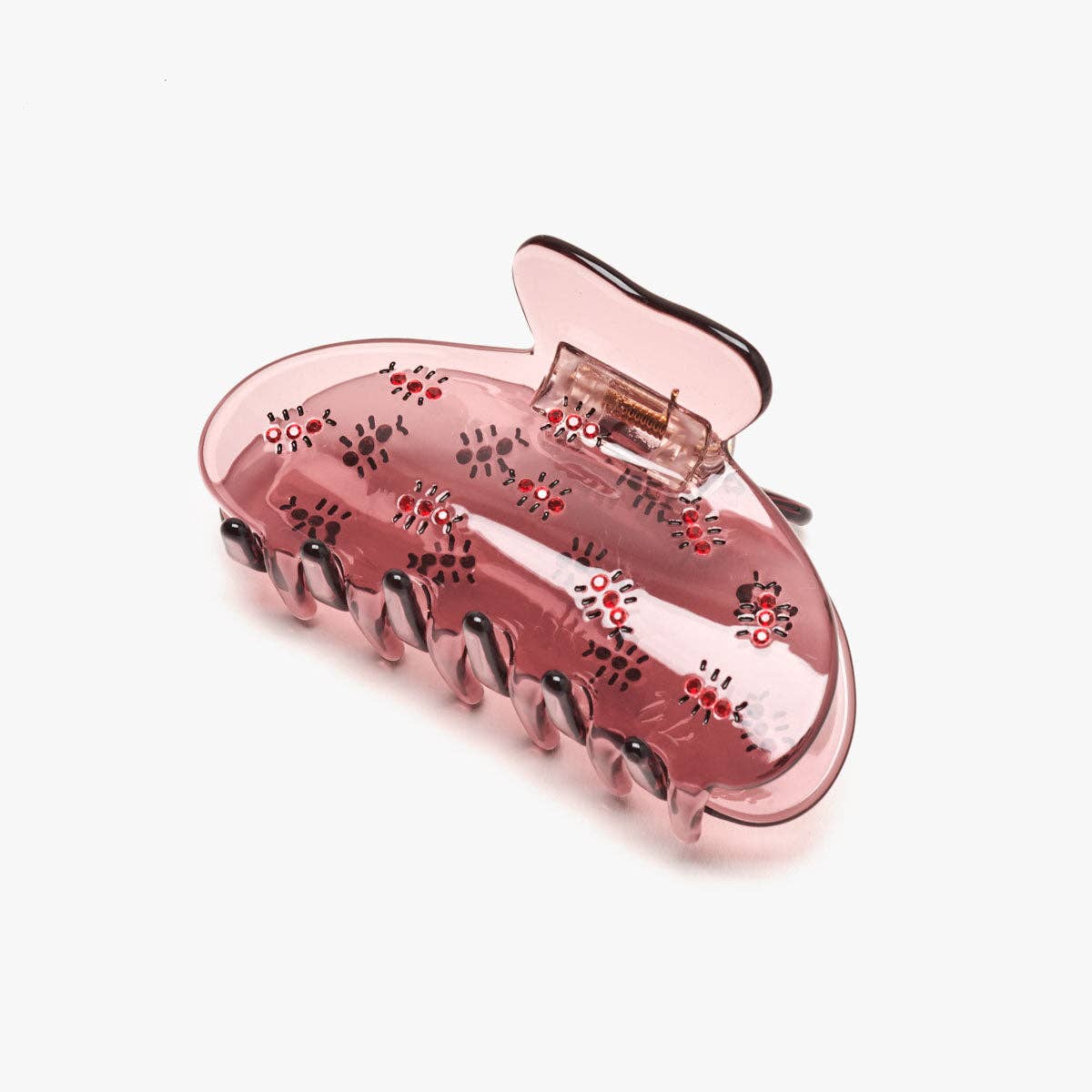 The Fire Ant Hair Claw features dark red rhinestone ants on a translucent blush-purple cellulose acetate claw for a playful, unexpected statement.