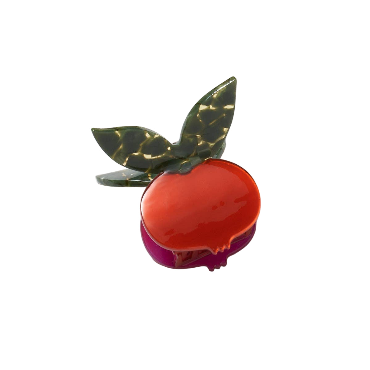 The Pomegranate Hair Claw features a glossy red fruit with deep green leaves and a whimsical butterfly-style handle for a playful botanical touch.