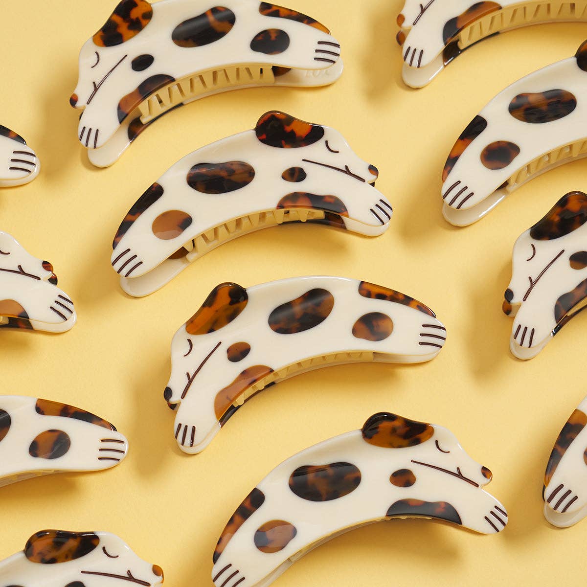 The Tortie Puppy Hair Claw features a playful dog shape with warm tortoise shell details, handcrafted from cellulose acetate with hand-painted accents.