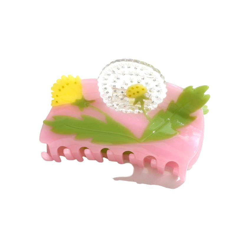 Add a playful botanical touch with the Dandelion Garden Hair Clip, crafted from colorful cellulose acetate with dimensional flowers and leafy details.