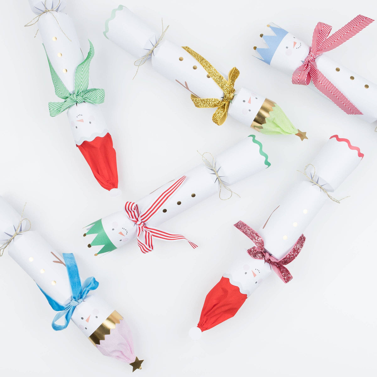 Christmas table crackers shaped like snowmen in assorted colorful designs